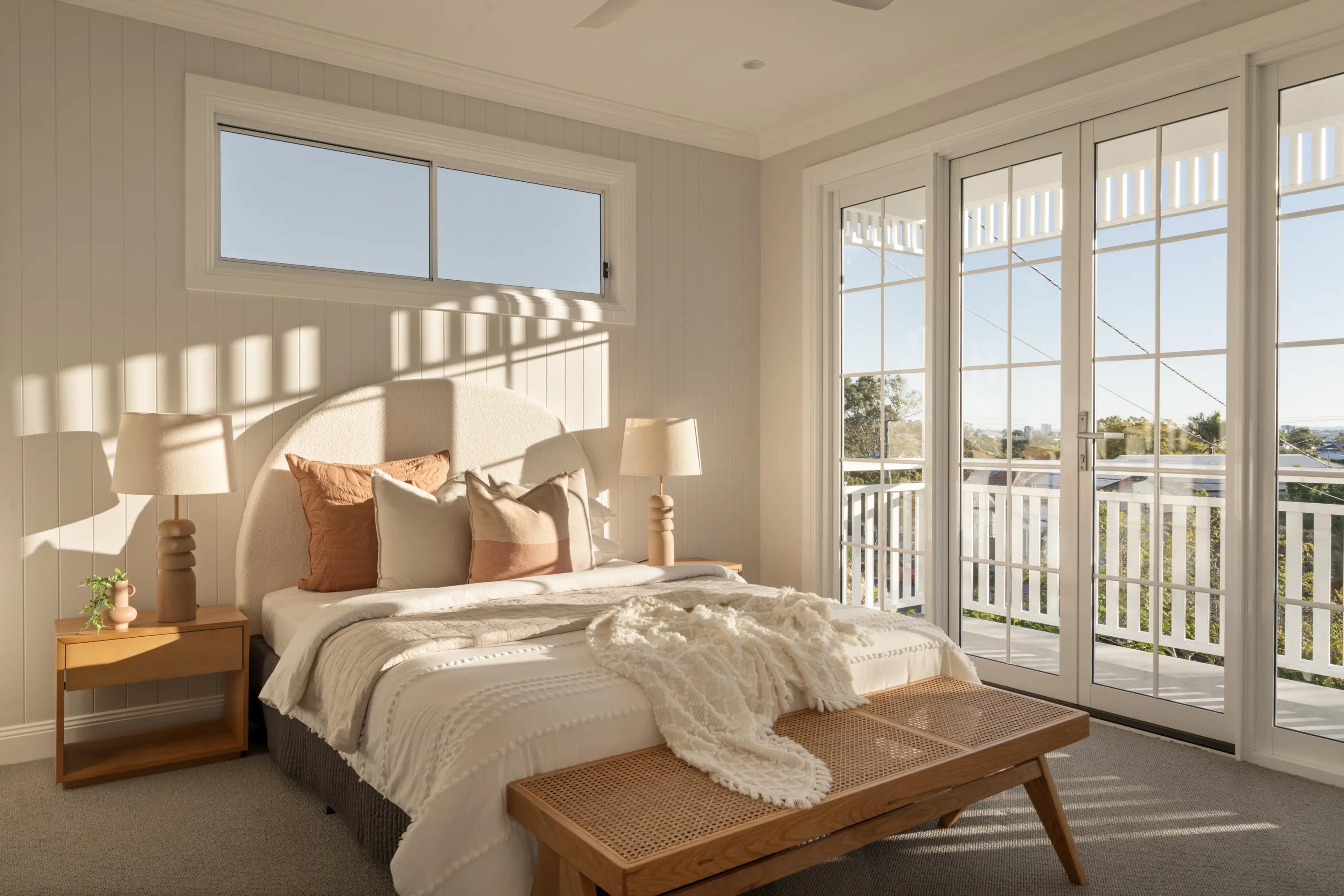 Bedroom with French doors opening to a balcony