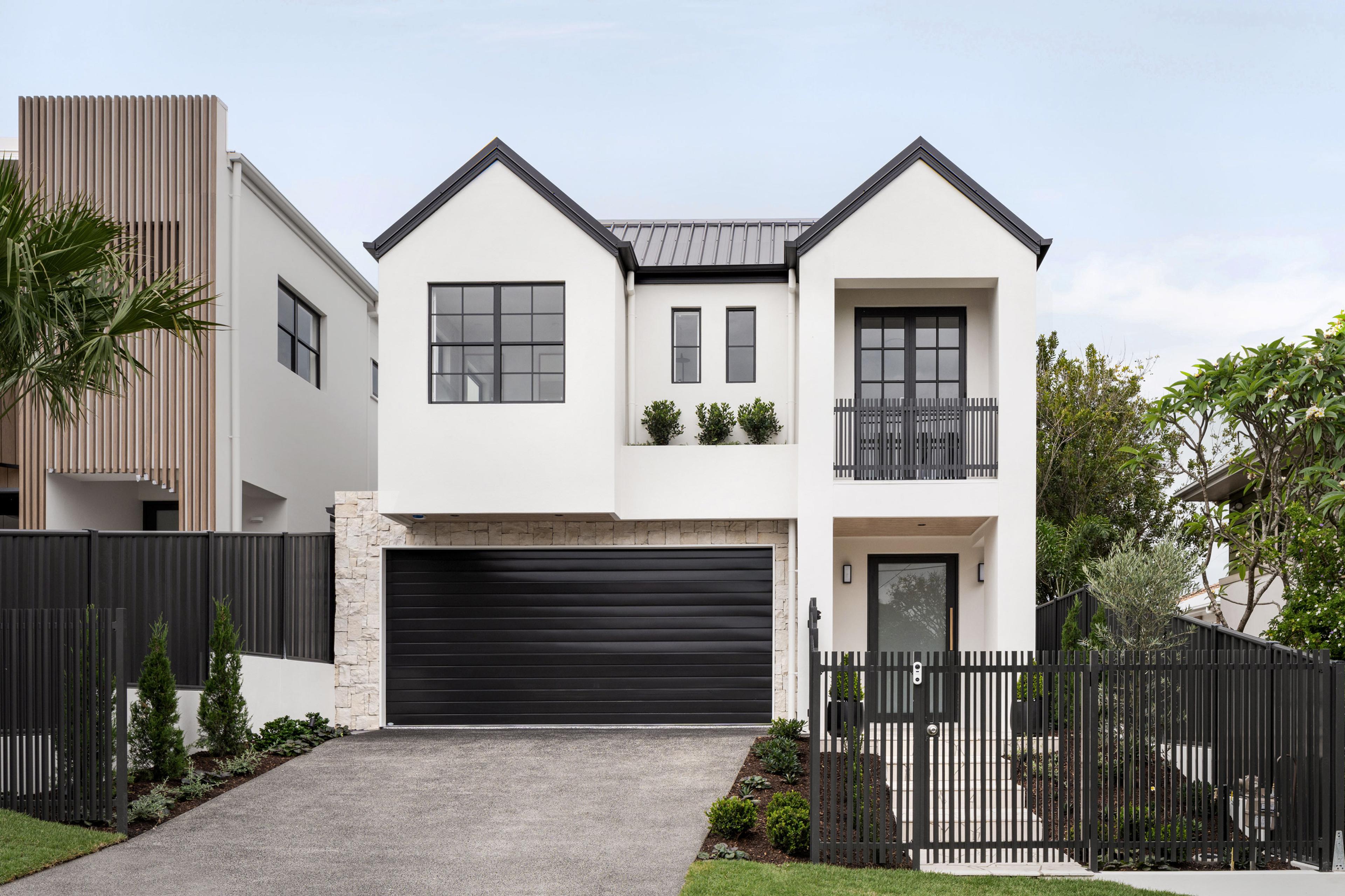 Two storey white home front facade with double garage