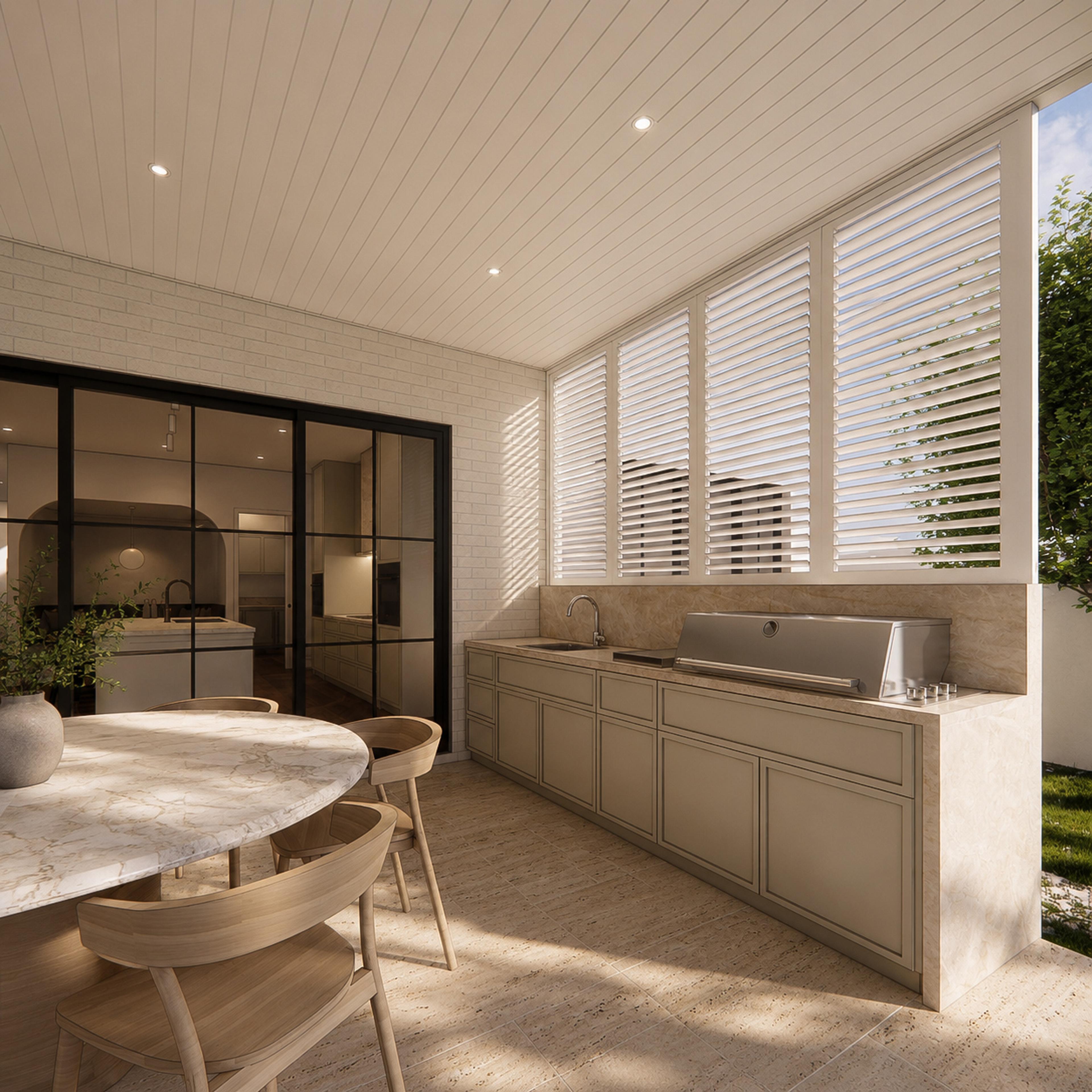 Covered alfresco kitchen with stainless barbecue, stone bench, plantation shutters and a round marble dining table