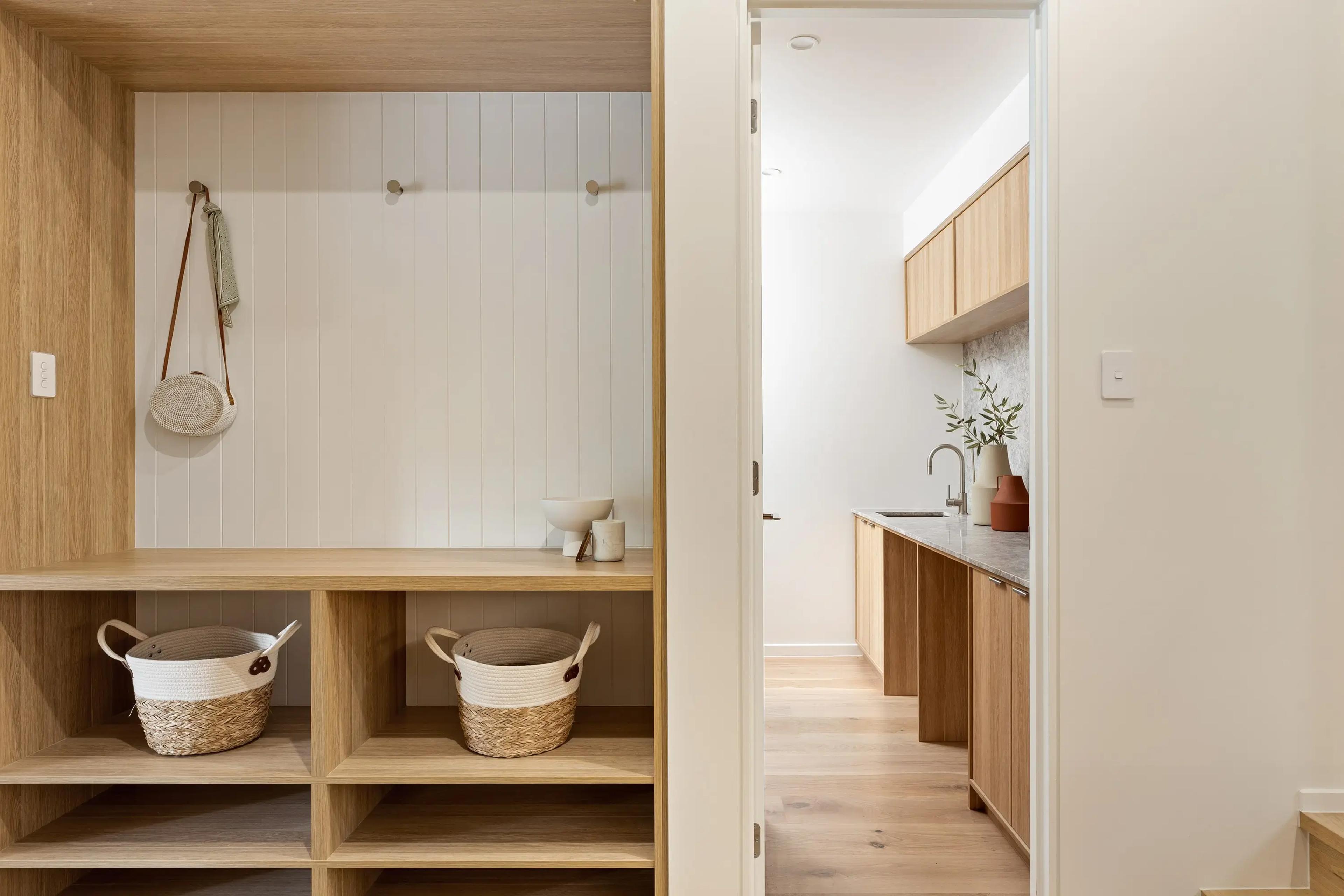 Butler's pantry and laundry with timber shelving and storage baskets