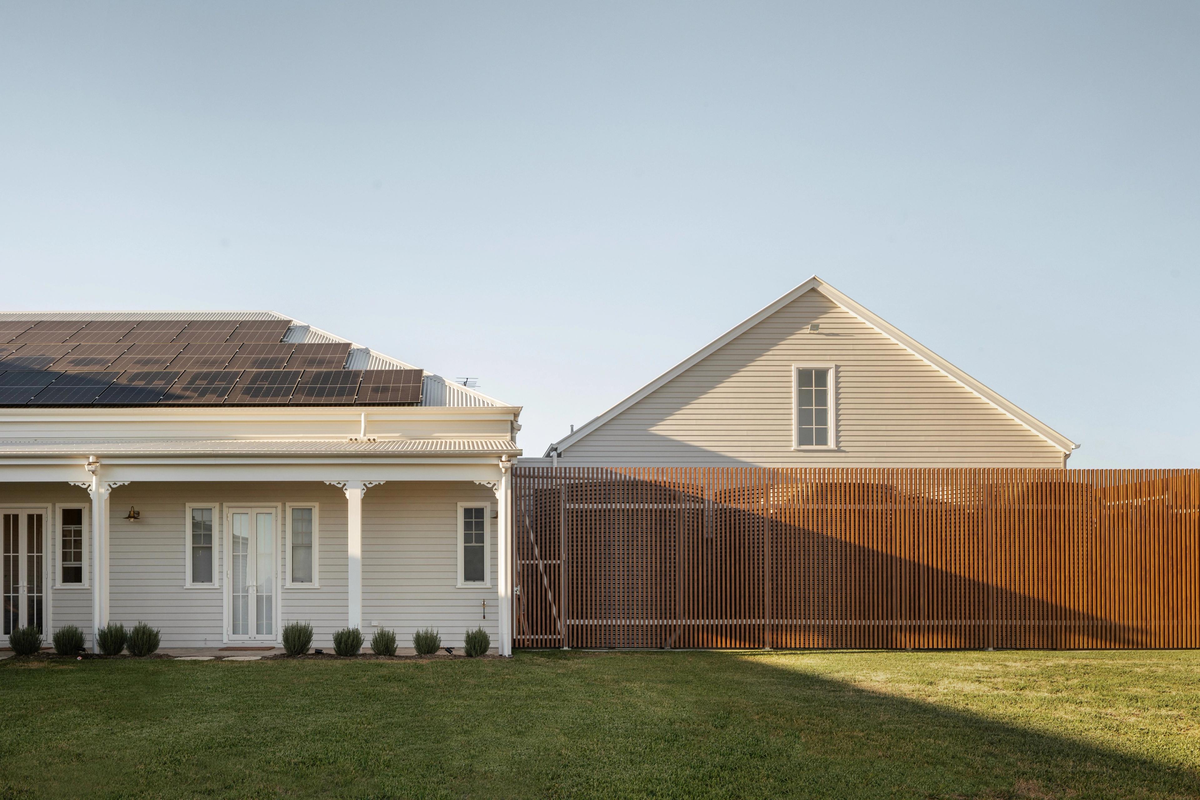Rear elevation with solar panels, verandah and timber screen fence