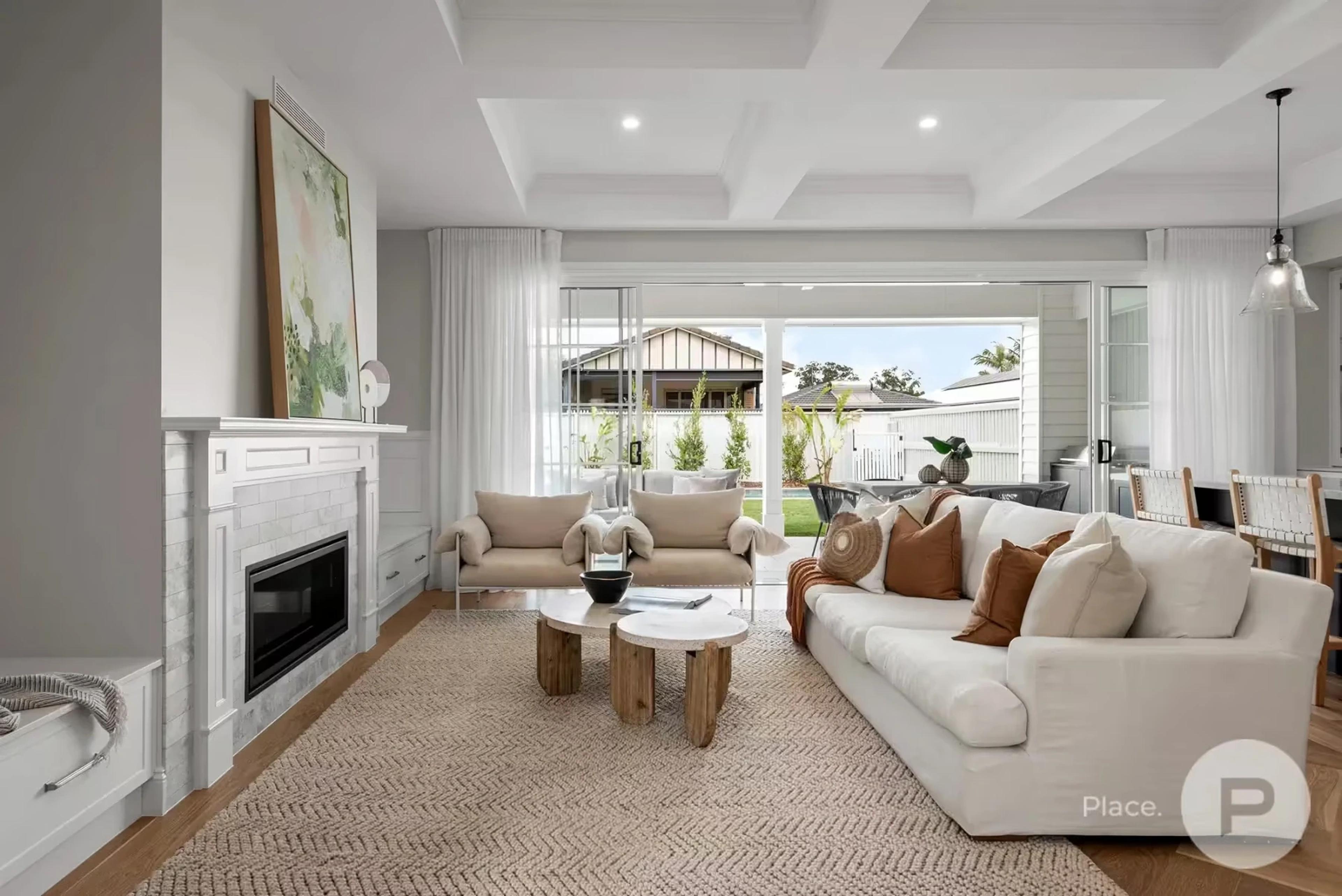 Living room with fireplace opening to covered patio