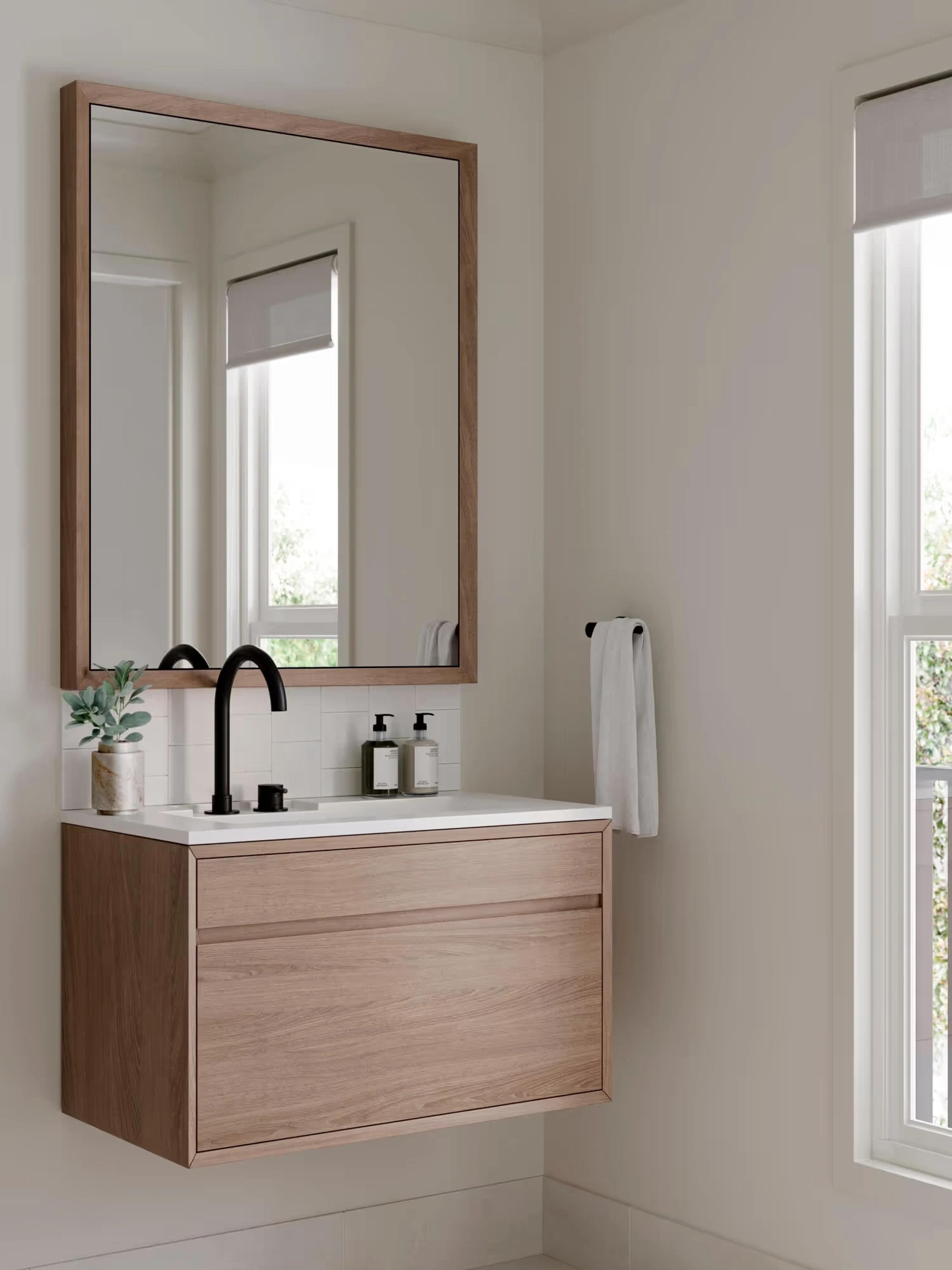 Bathroom with timber vanity, framed mirror and black tapware
