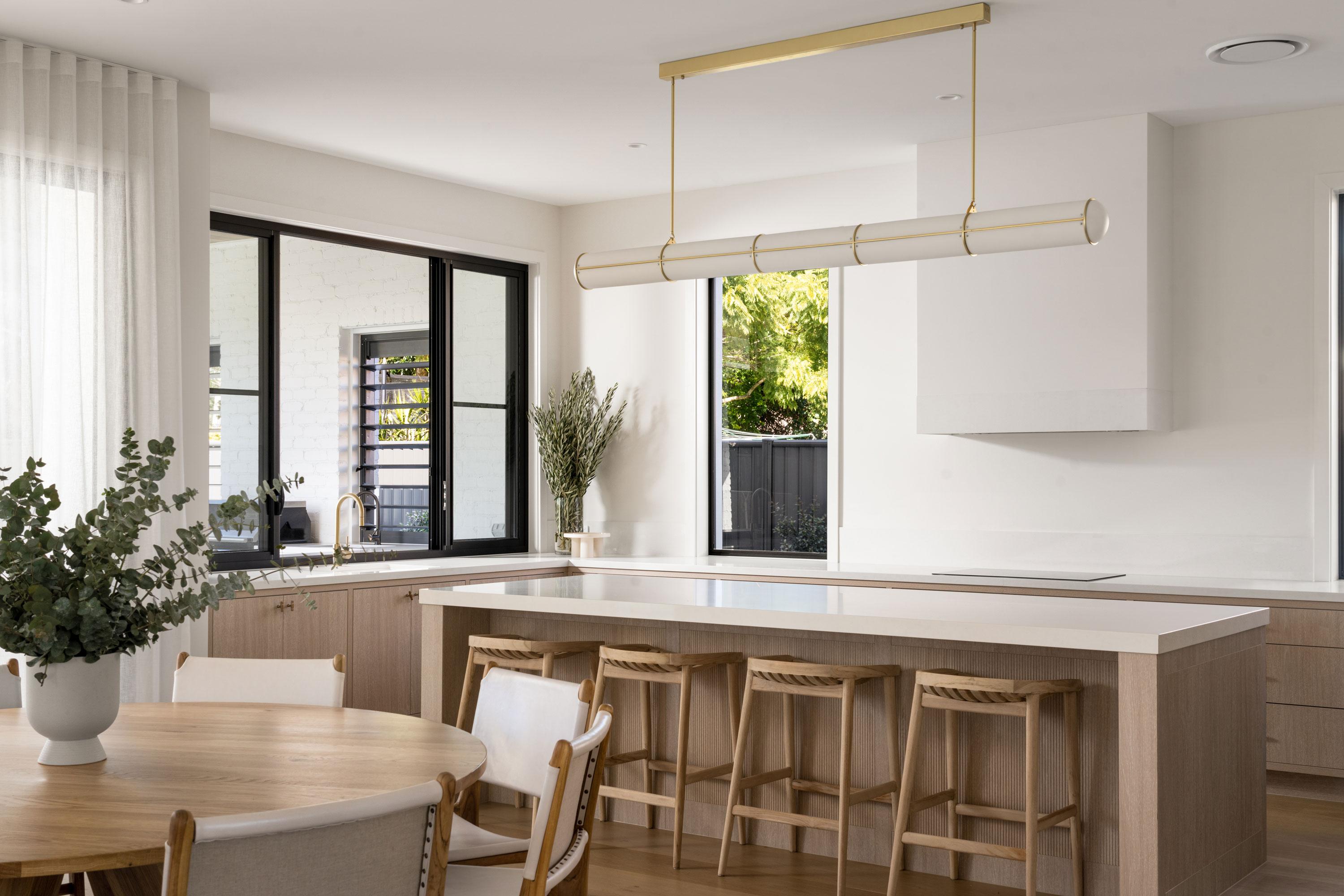 Modern kitchen design with large picture window overlooking backyard