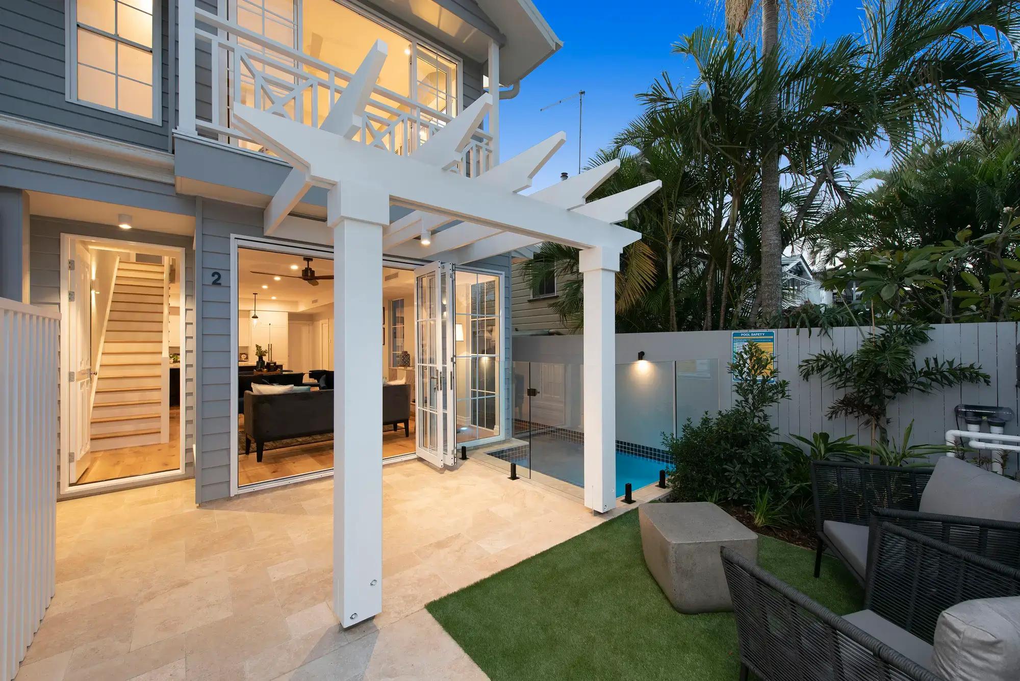 Two storey townhouse exterior with courtyard, pergola and pool