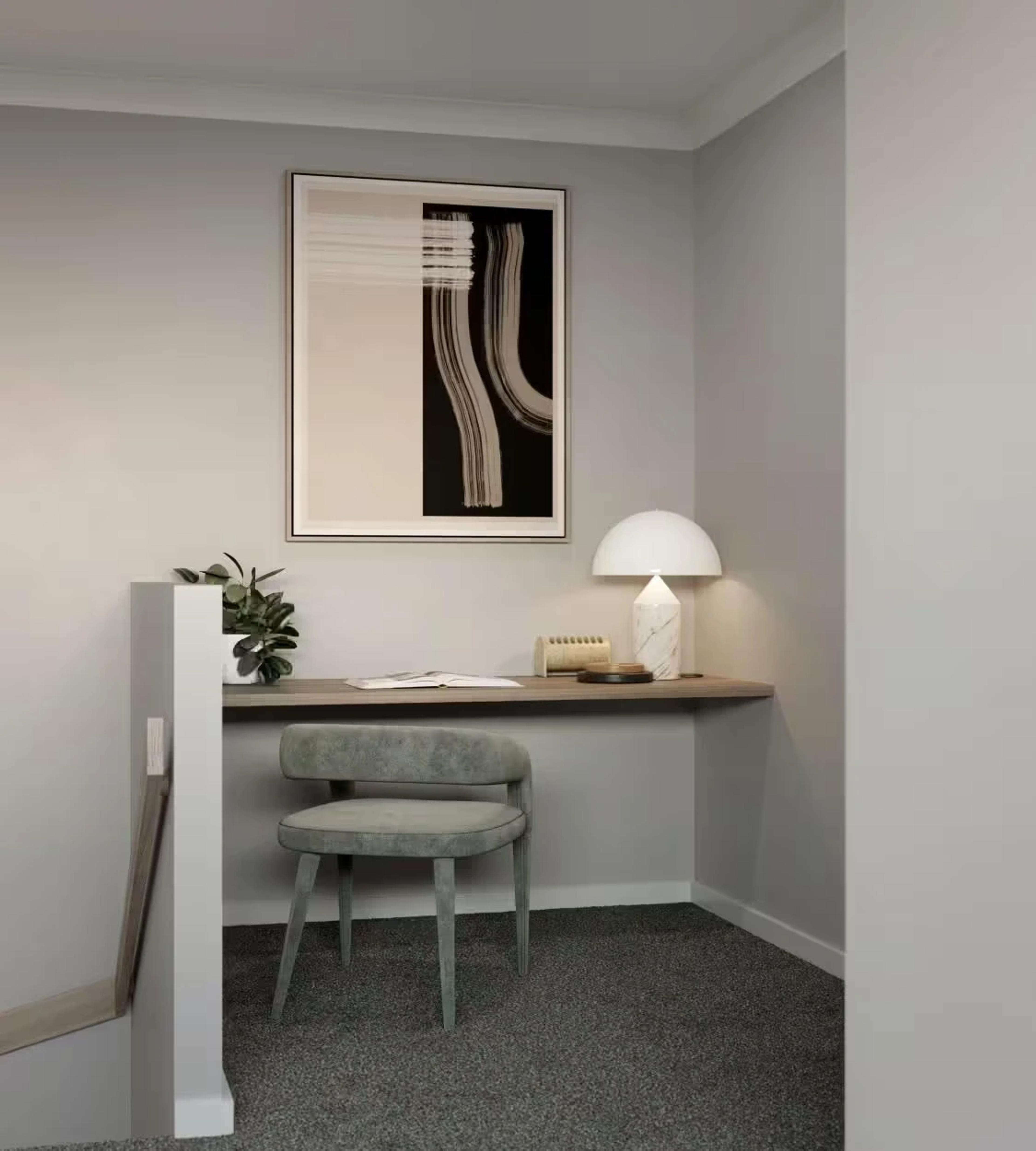 Compact study nook with floating desk, chair and framed artwork
