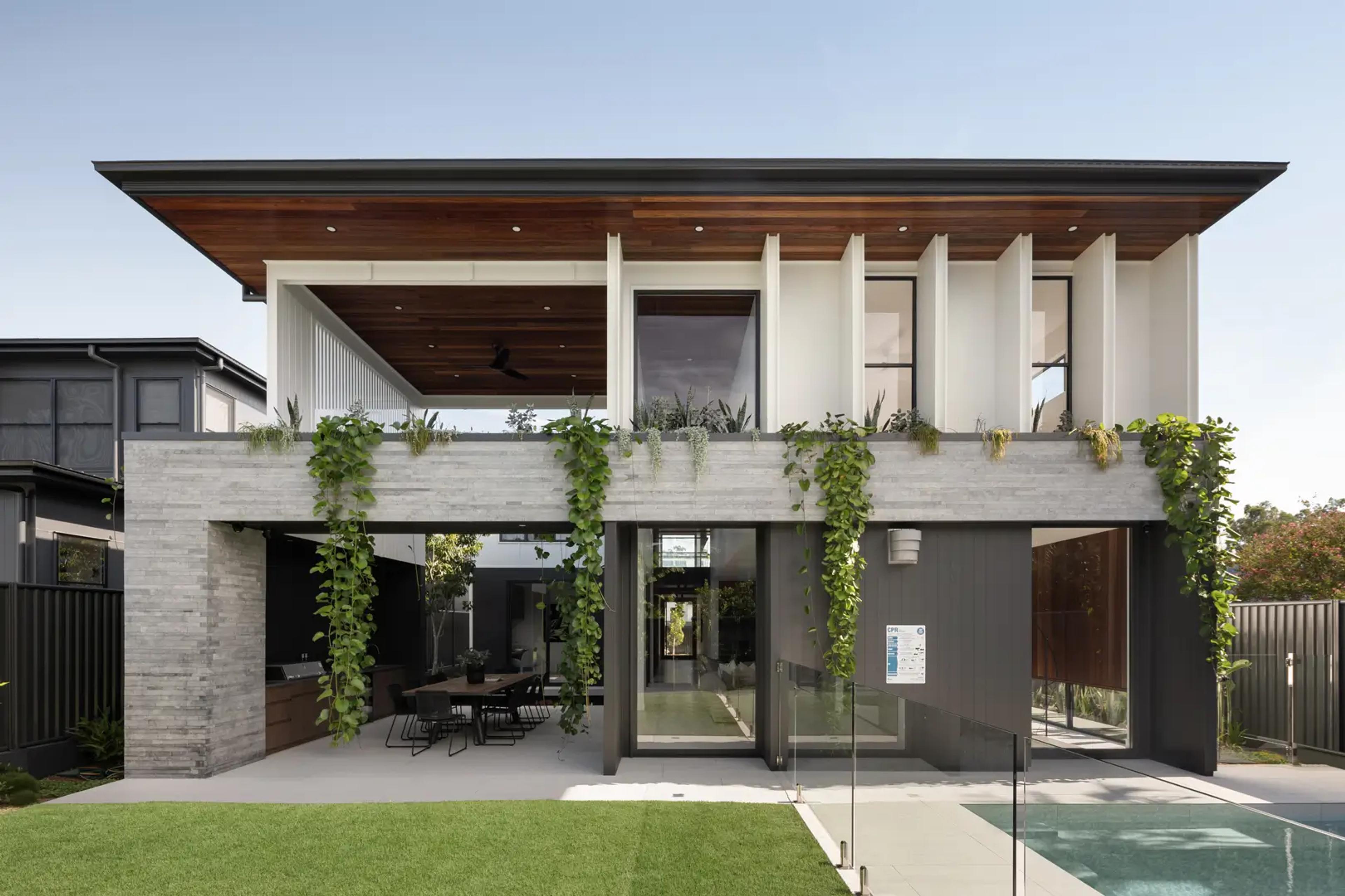 Rear facade with covered patio beside pool