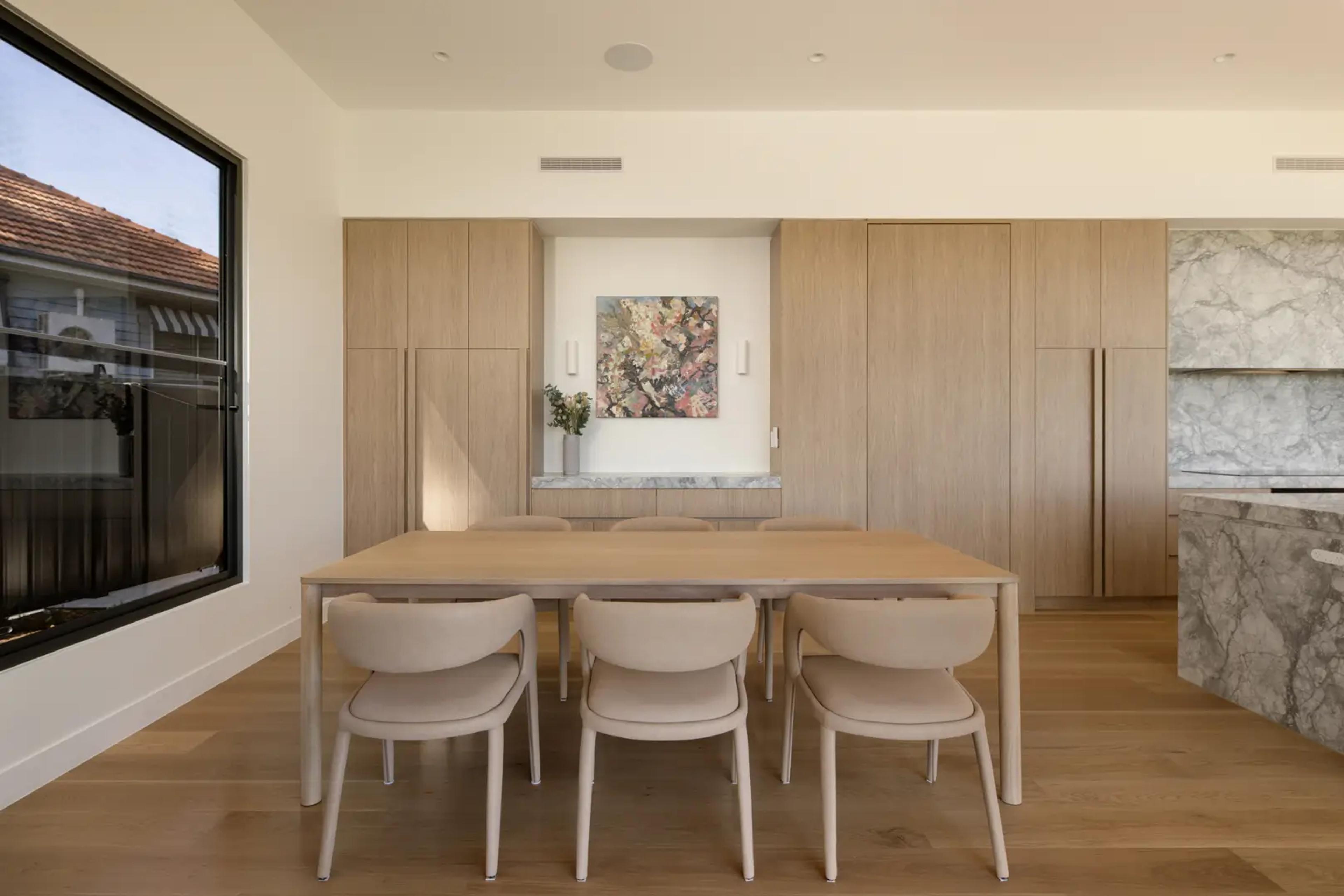 Dining area with timber table and built in cabinetry