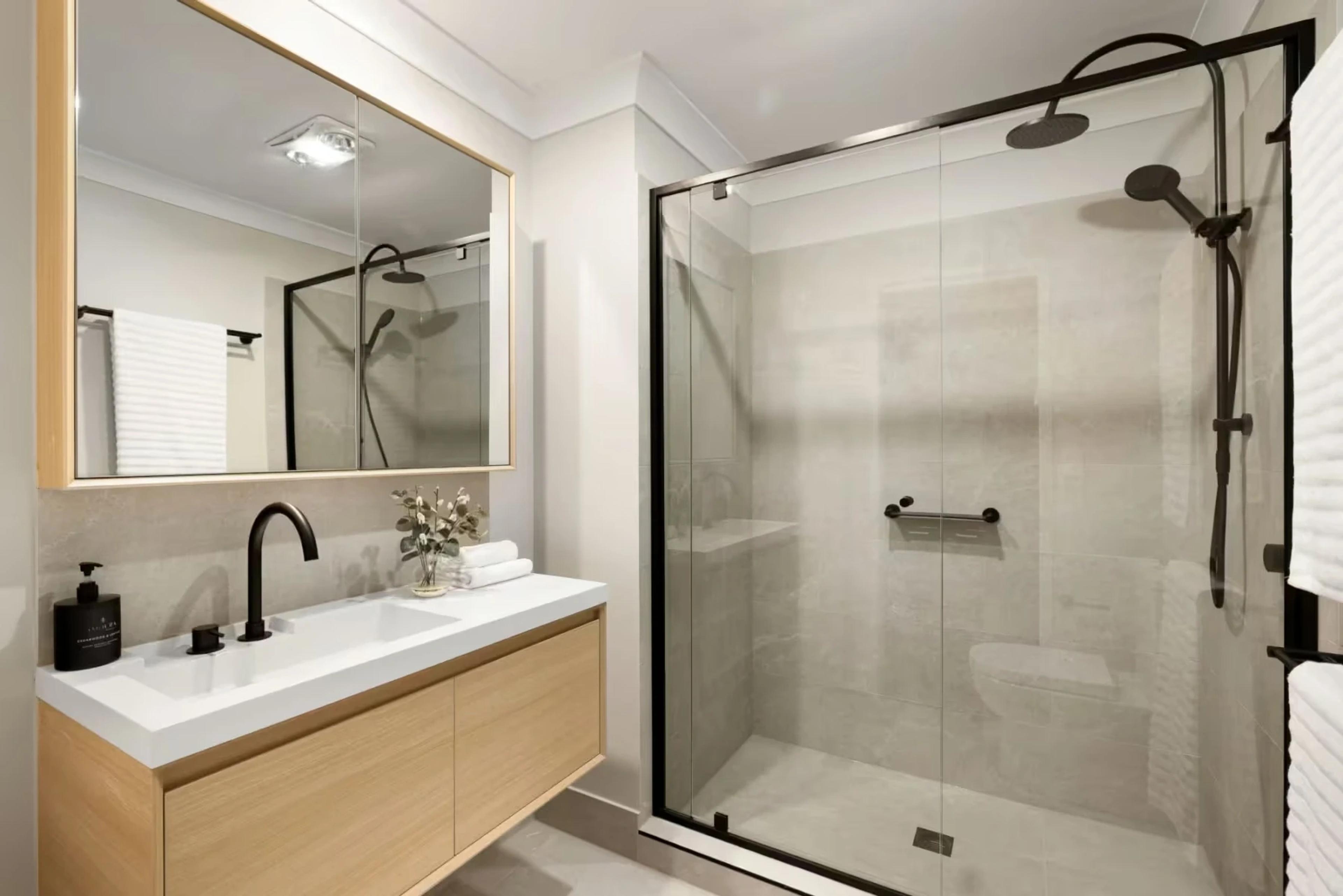 Bathroom with timber vanity and glass shower