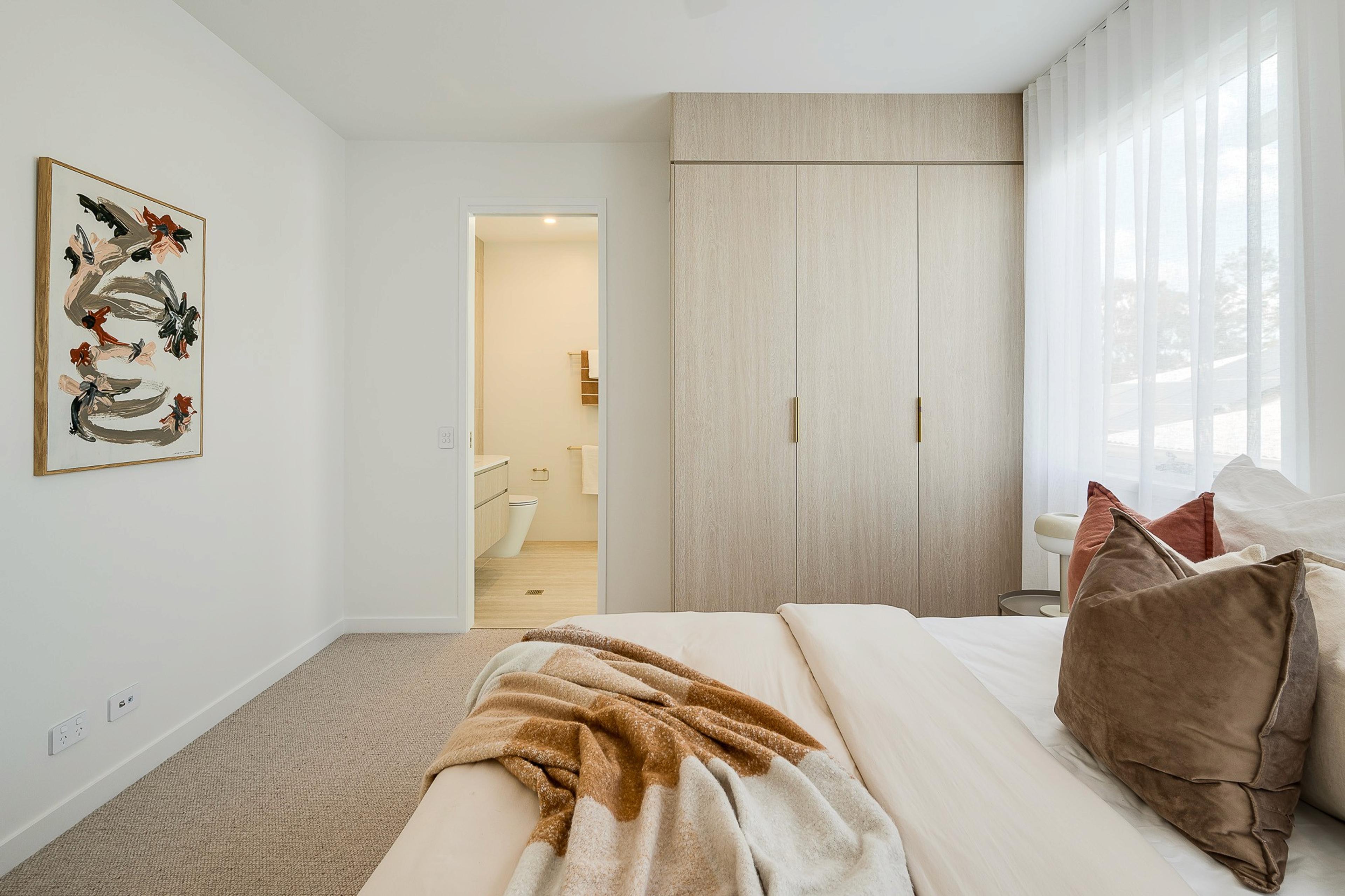 Bedroom with wardrobe and ensuite beyond