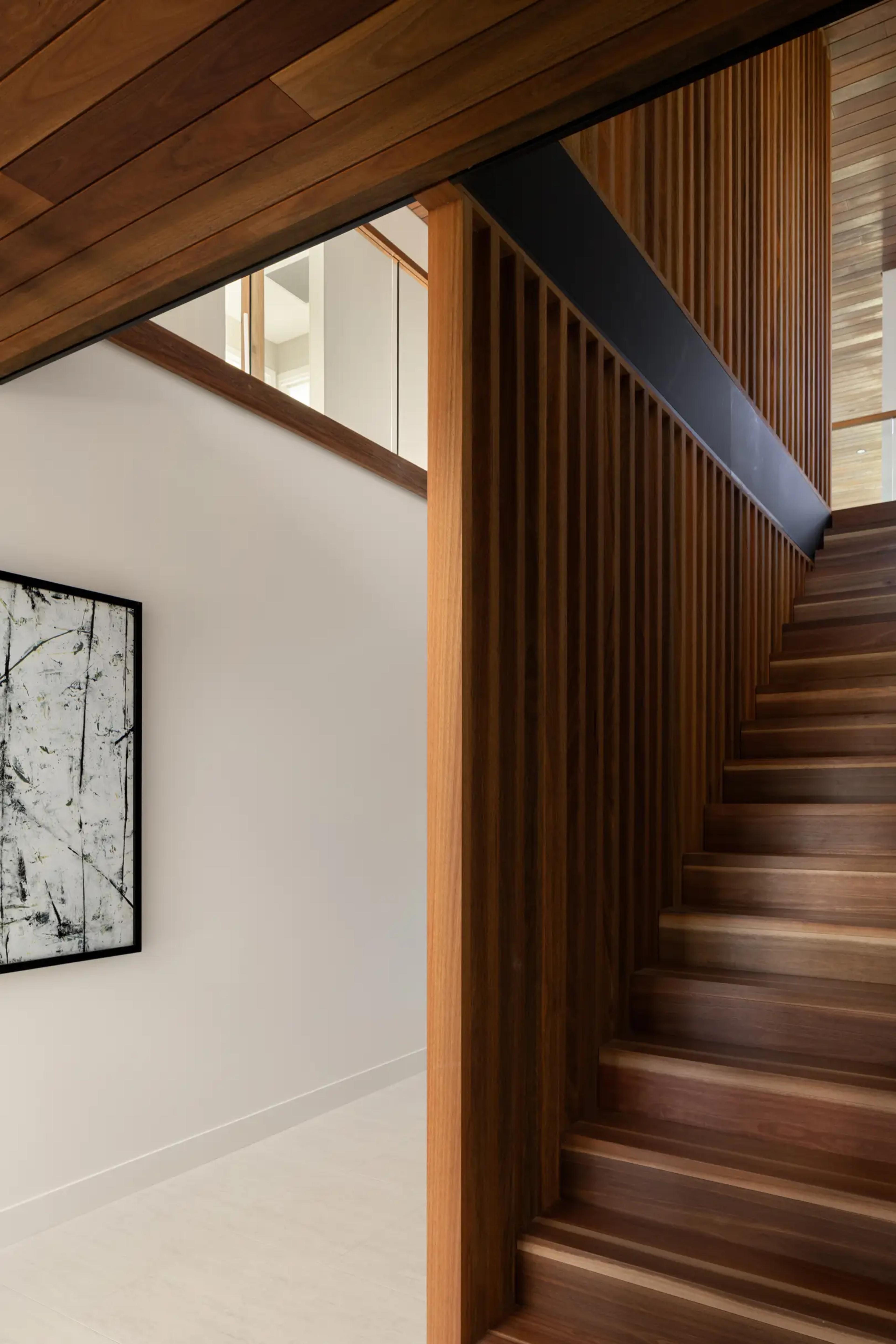 Timber staircase with battens and framed artwork