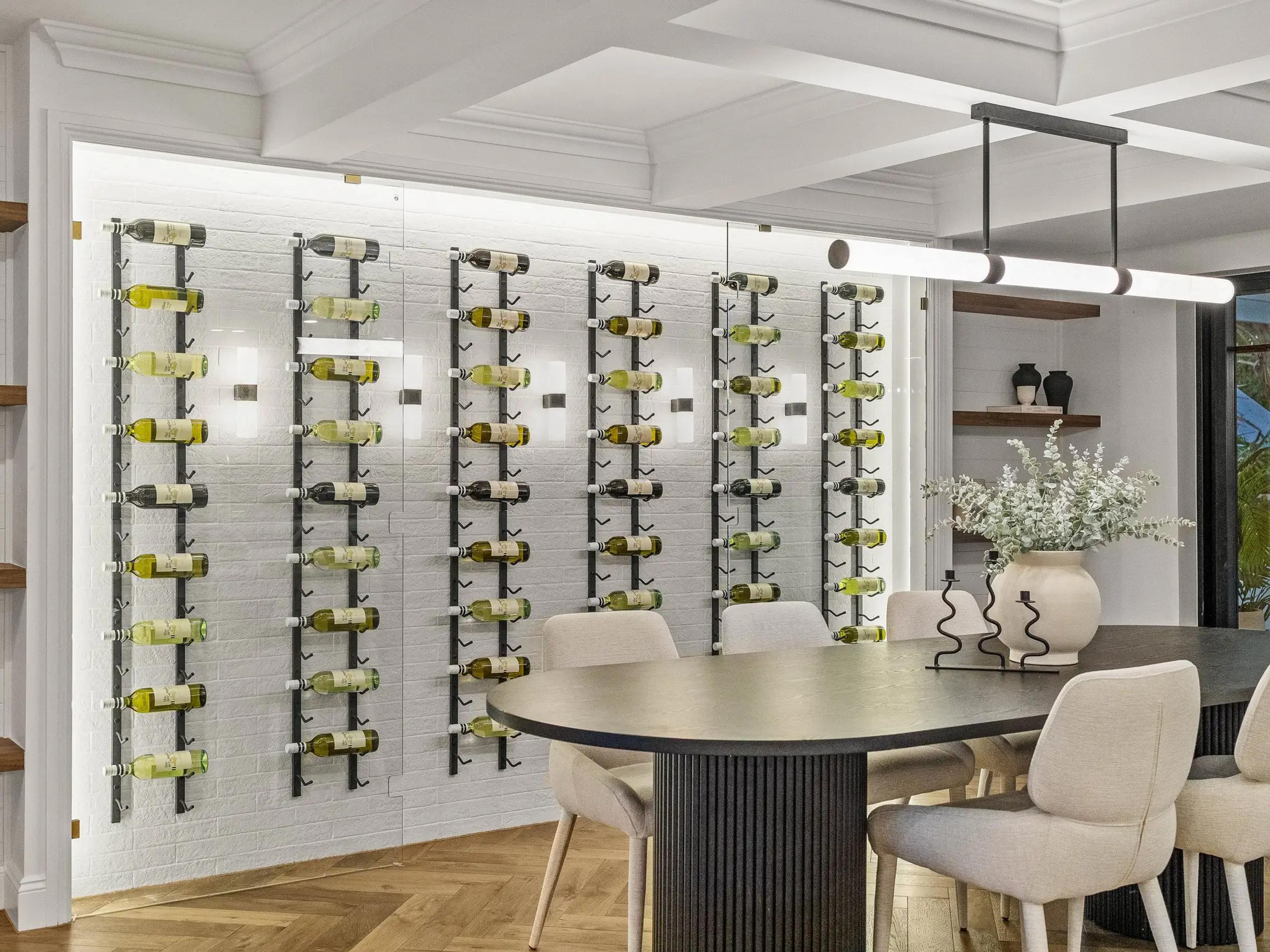 Dining room with wall mounted wine display racks