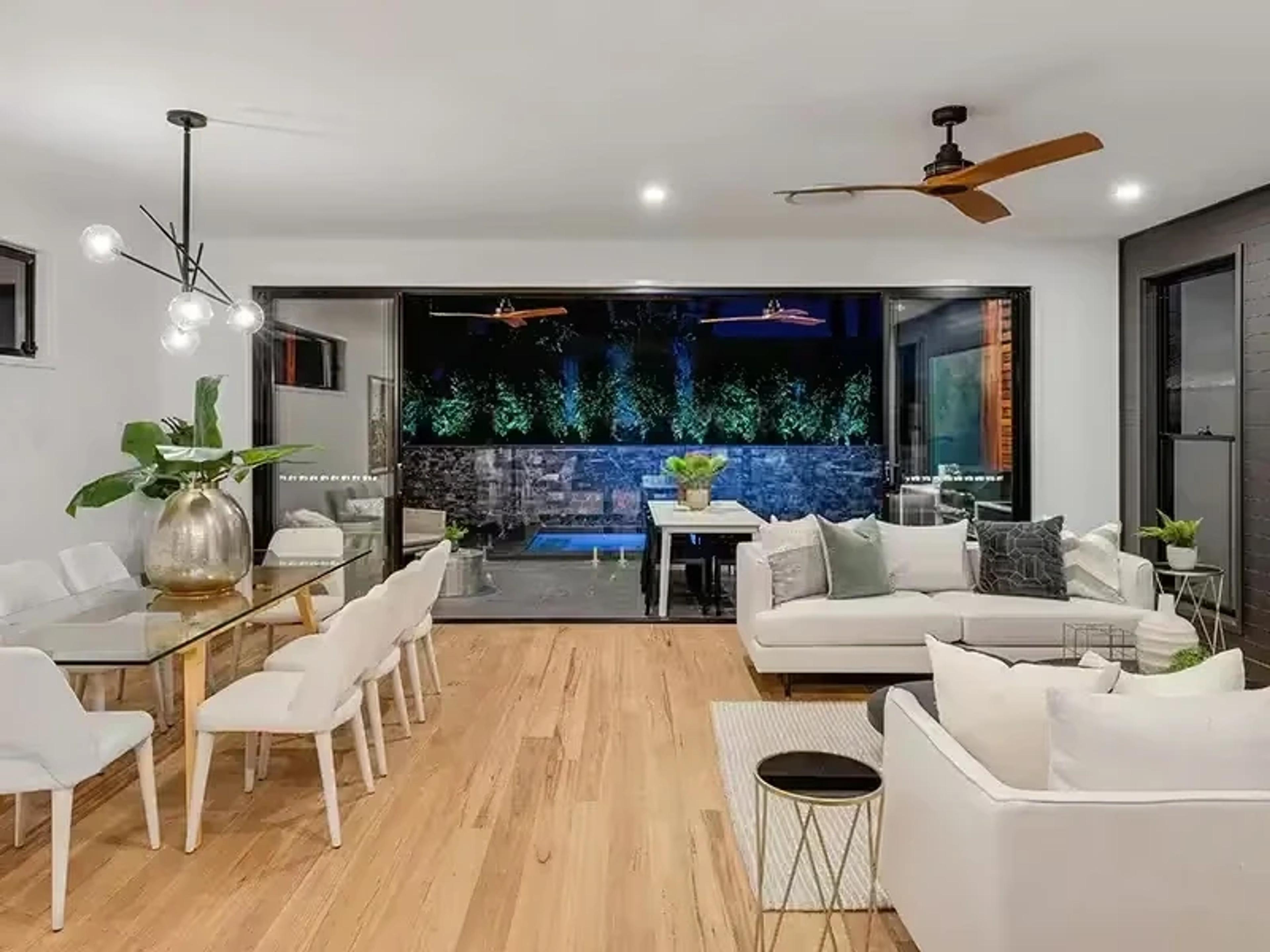 Open plan living and dining room opening to pool courtyard