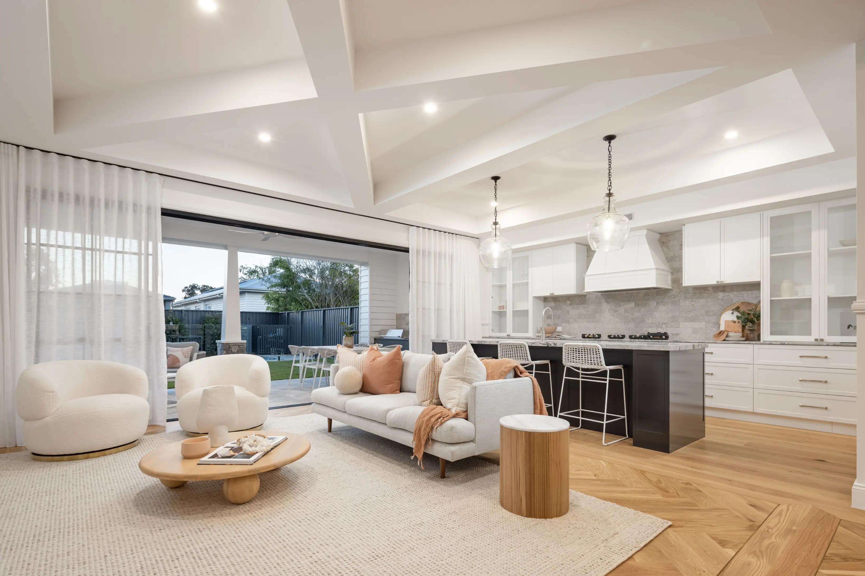 An open plan layout showing living and kitchen with light timber floors