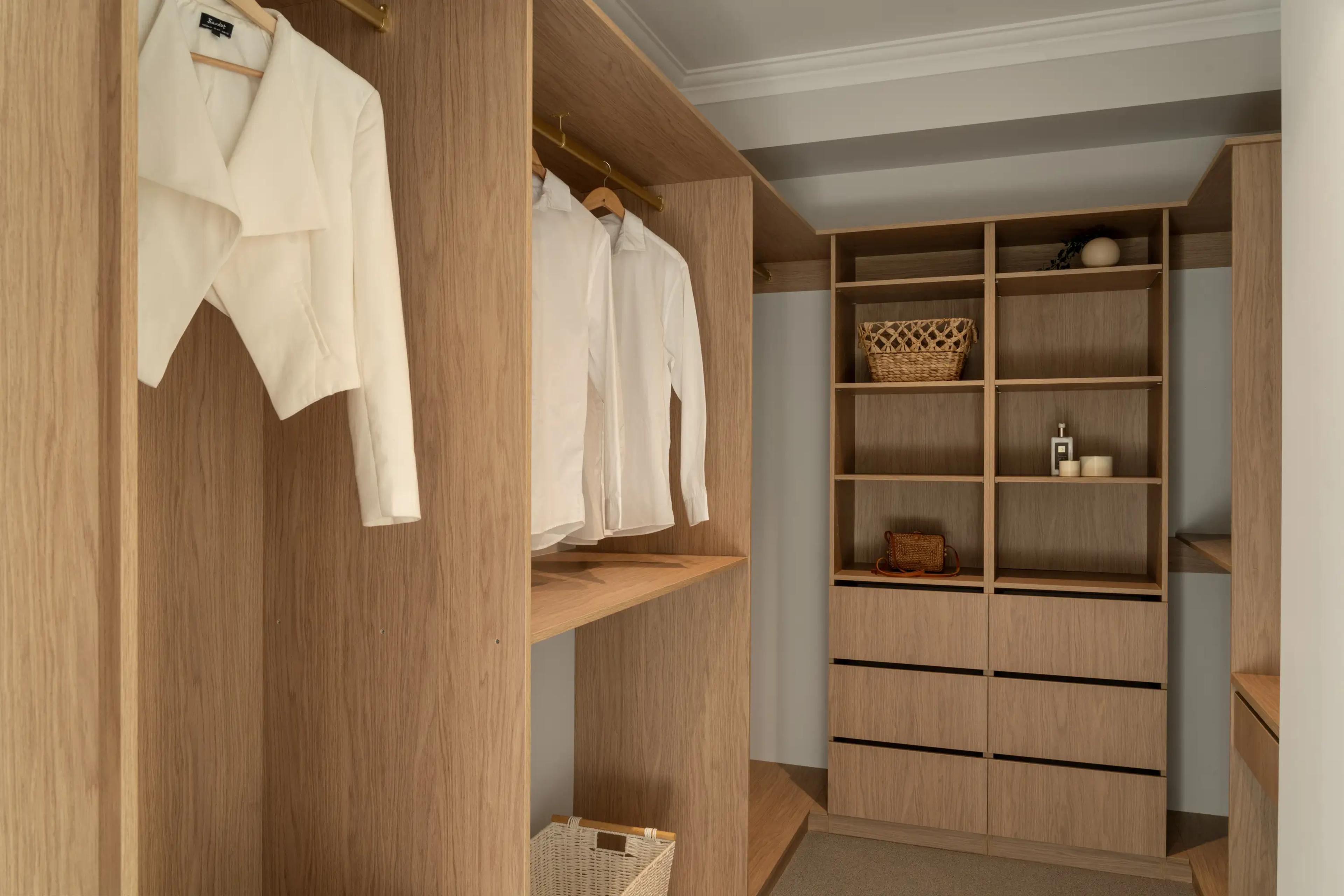 Walk in wardrobe with timber shelving and hanging space