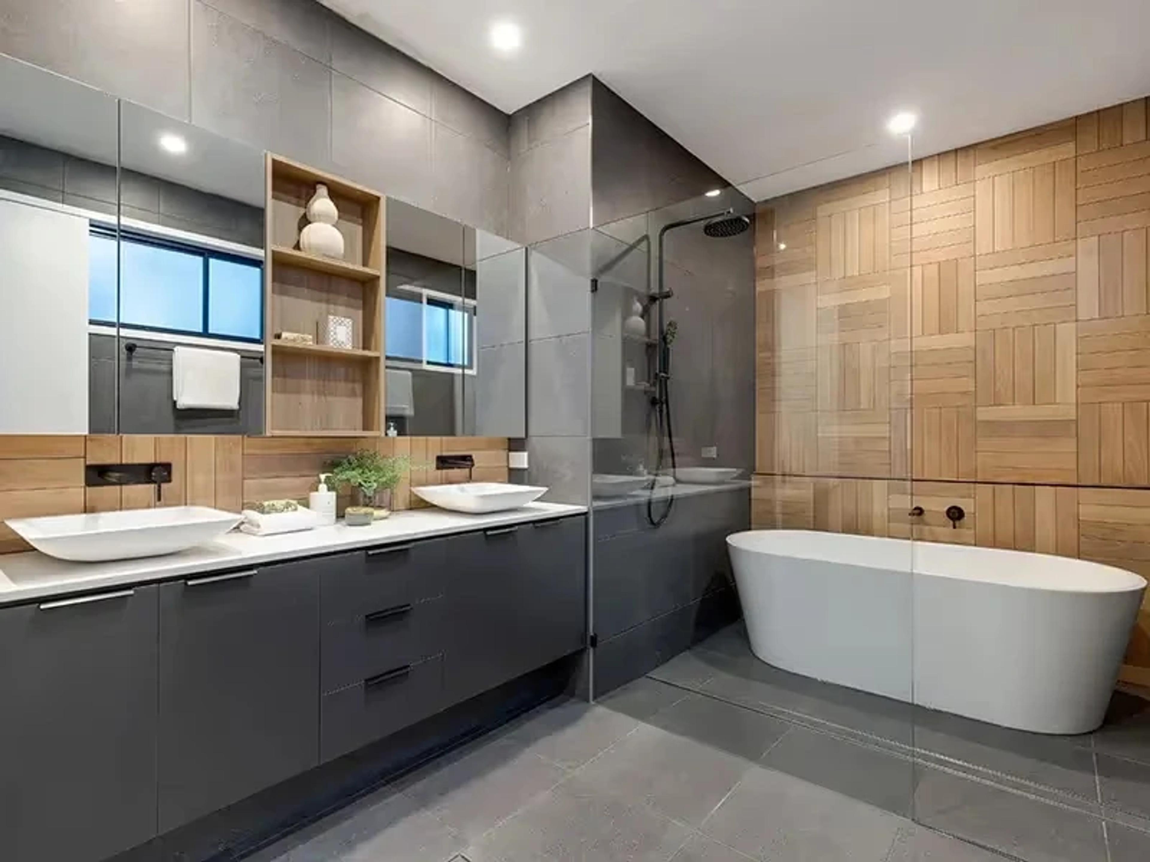 Bathroom with double vanity, freestanding bath and timber tiles