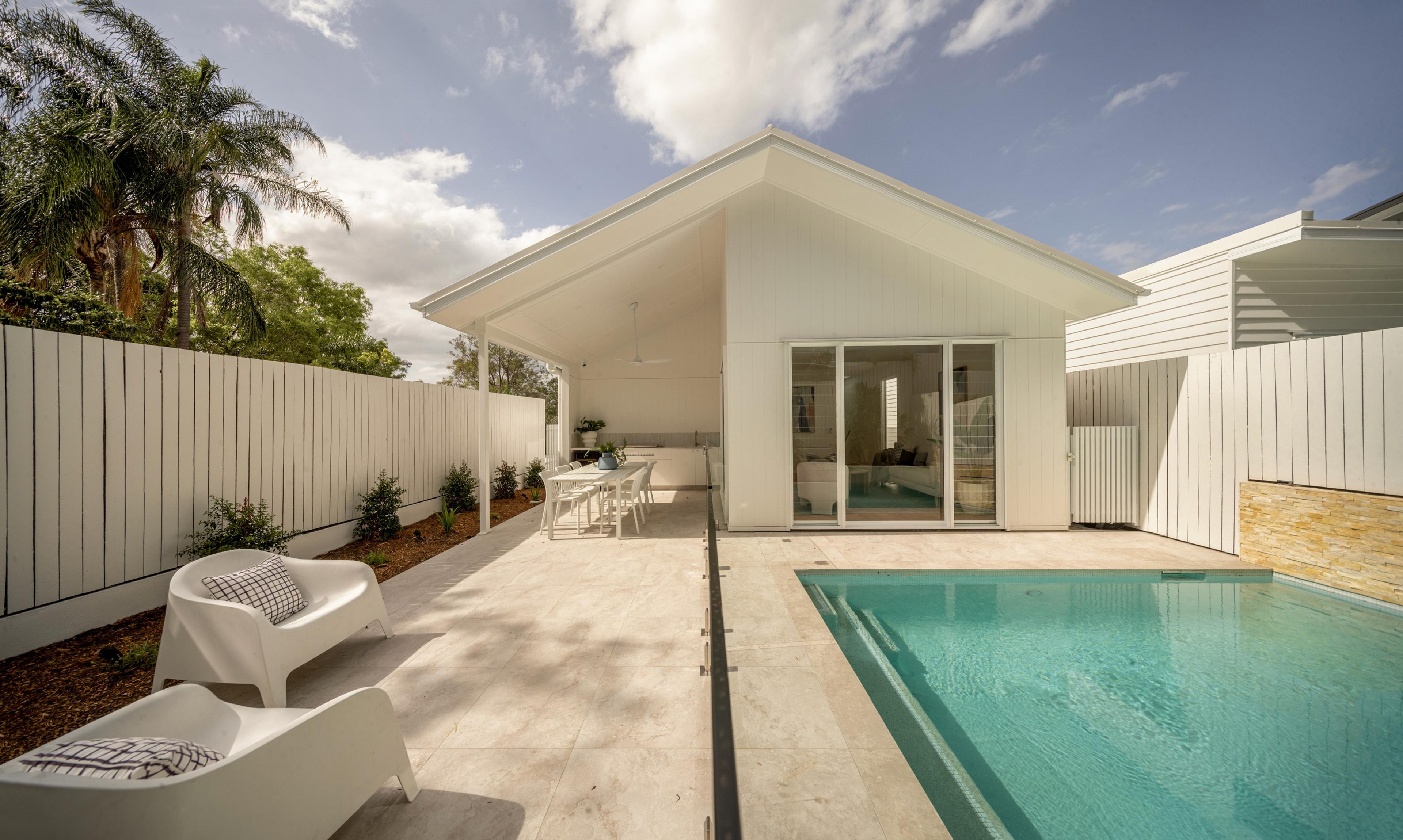 Rear gabled pavilion beside swimming pool and paved terrace