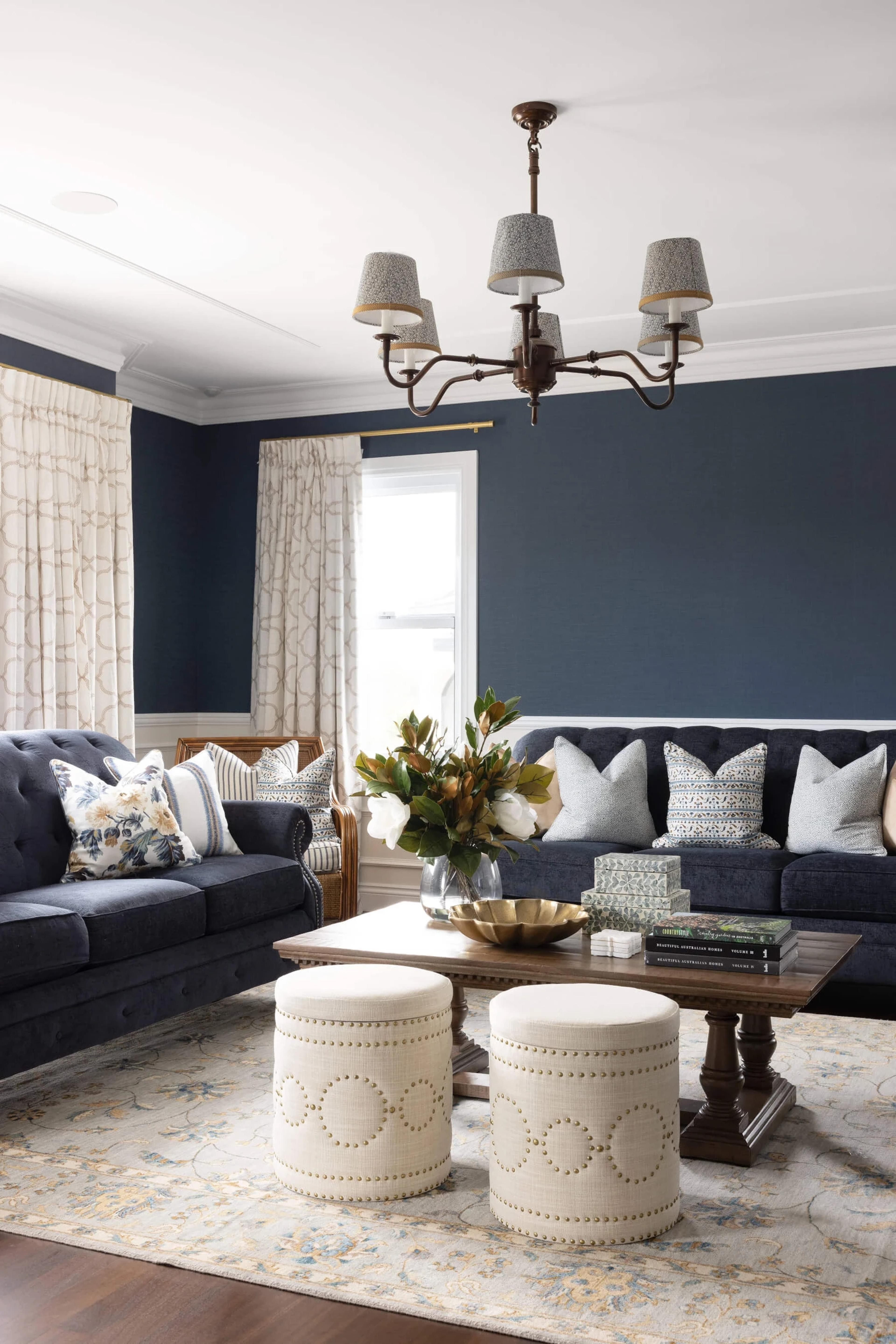 Navy living room with tufted sofas and coffee table