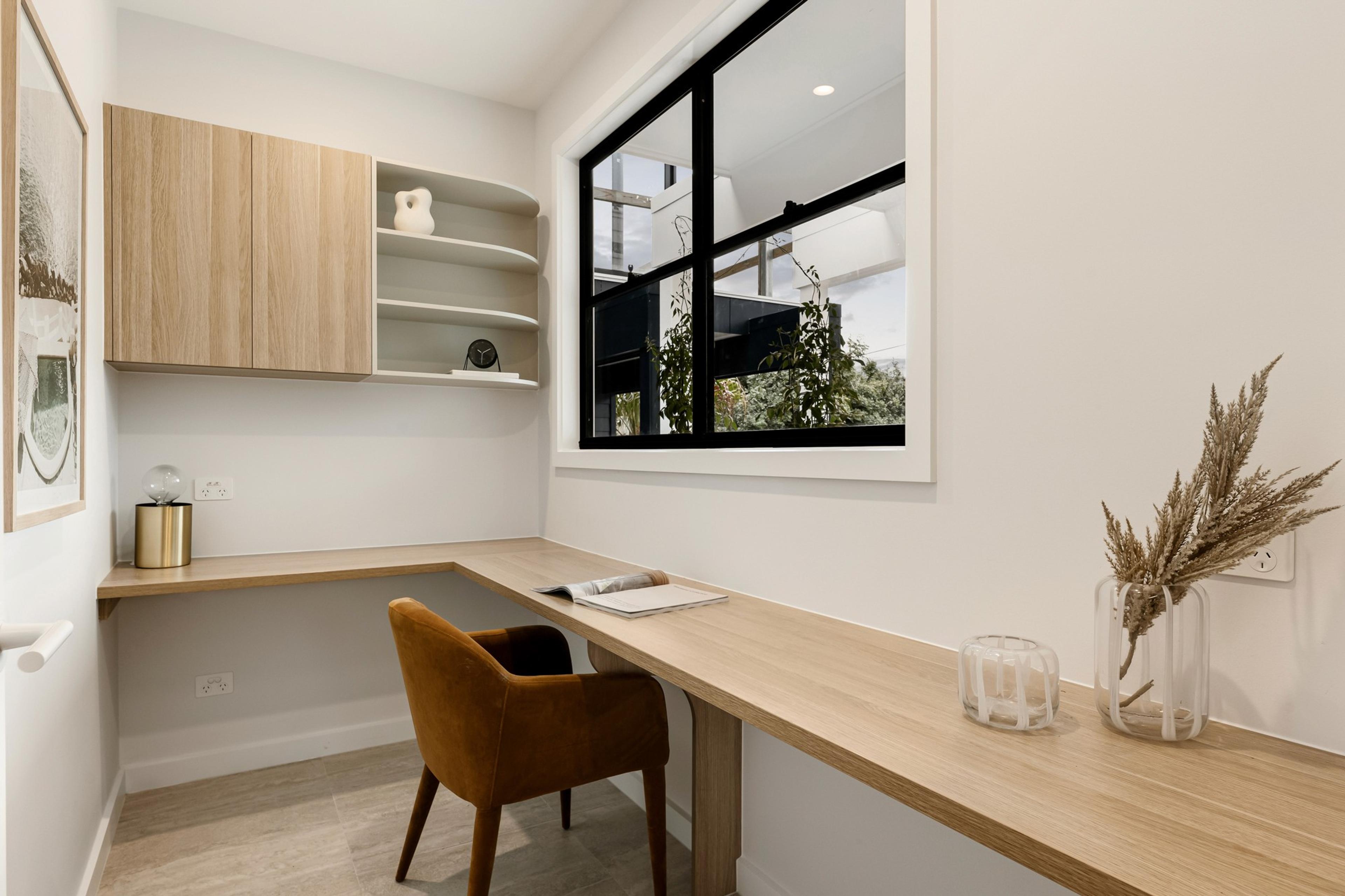 Built in study nook with timber desk, shelving and window