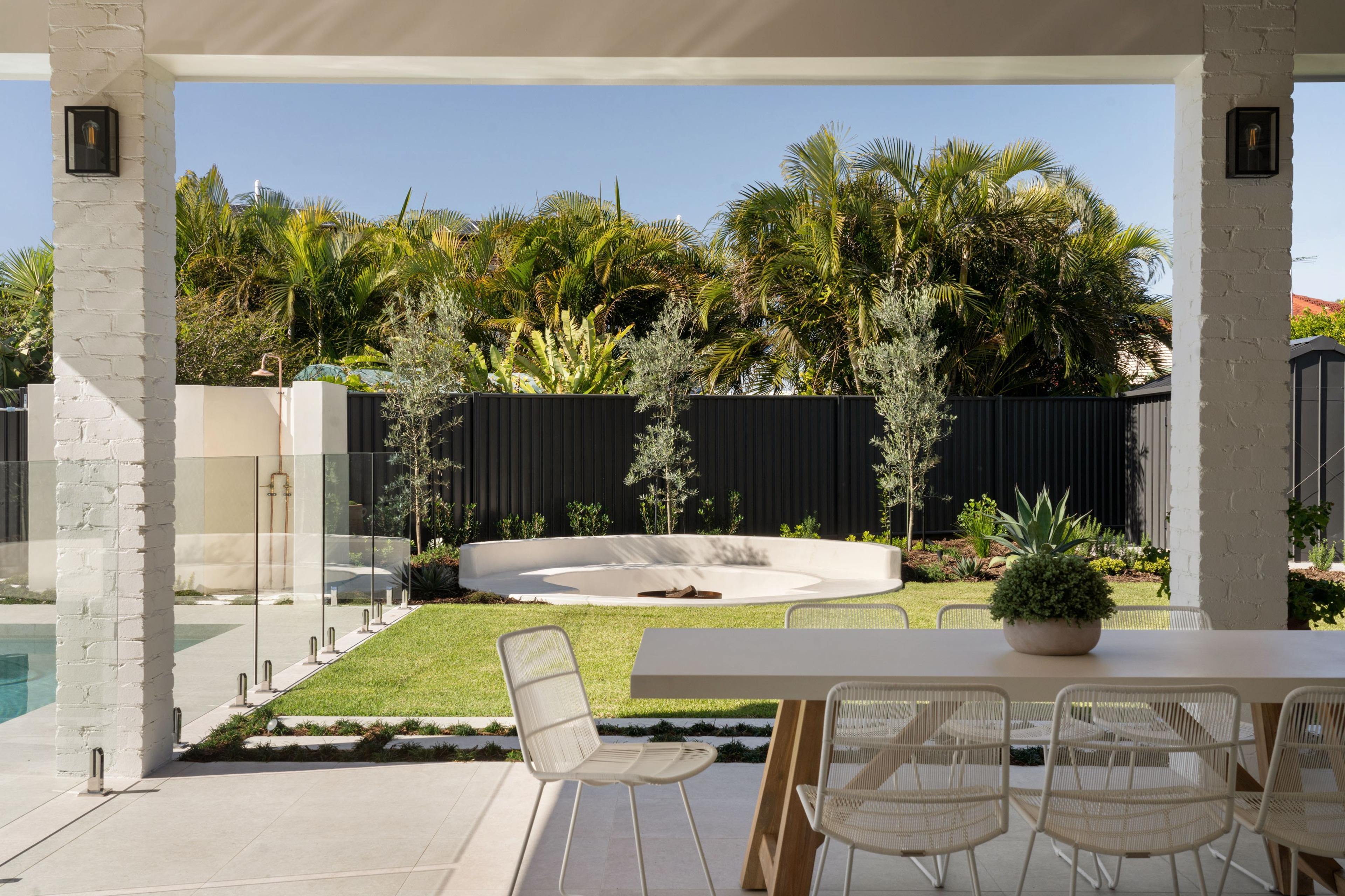 Resort style backyard with fire pit and modern rear facade