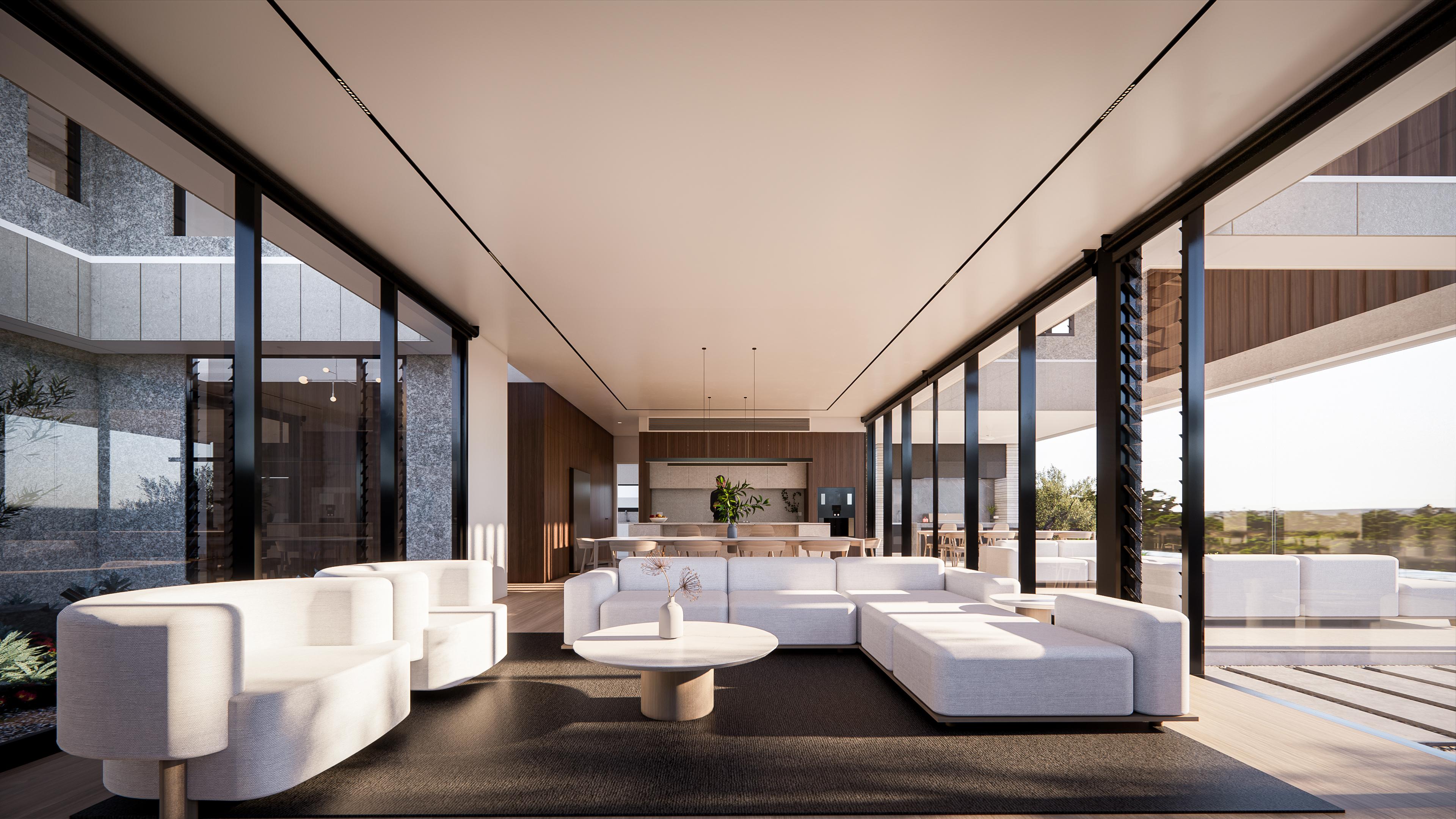 Bright lounge with curved white sofas and coffee table, framed by glass walls toward the kitchen