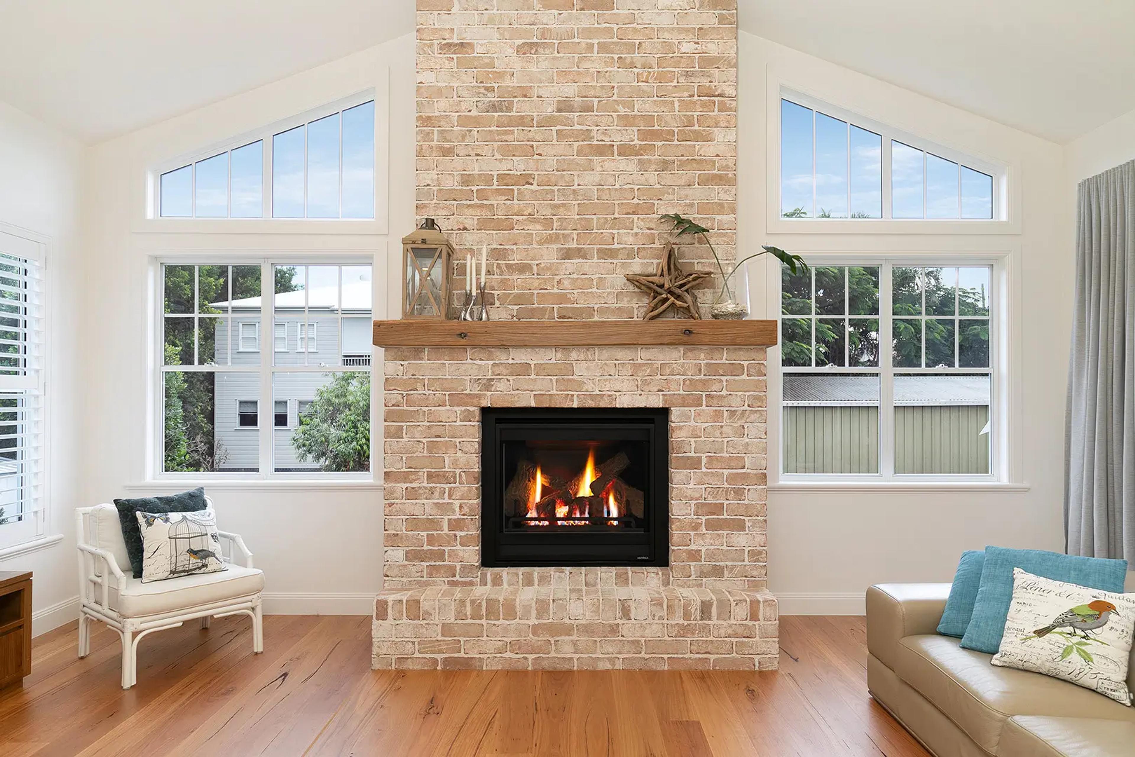 Living room with brick fireplace and timber mantel