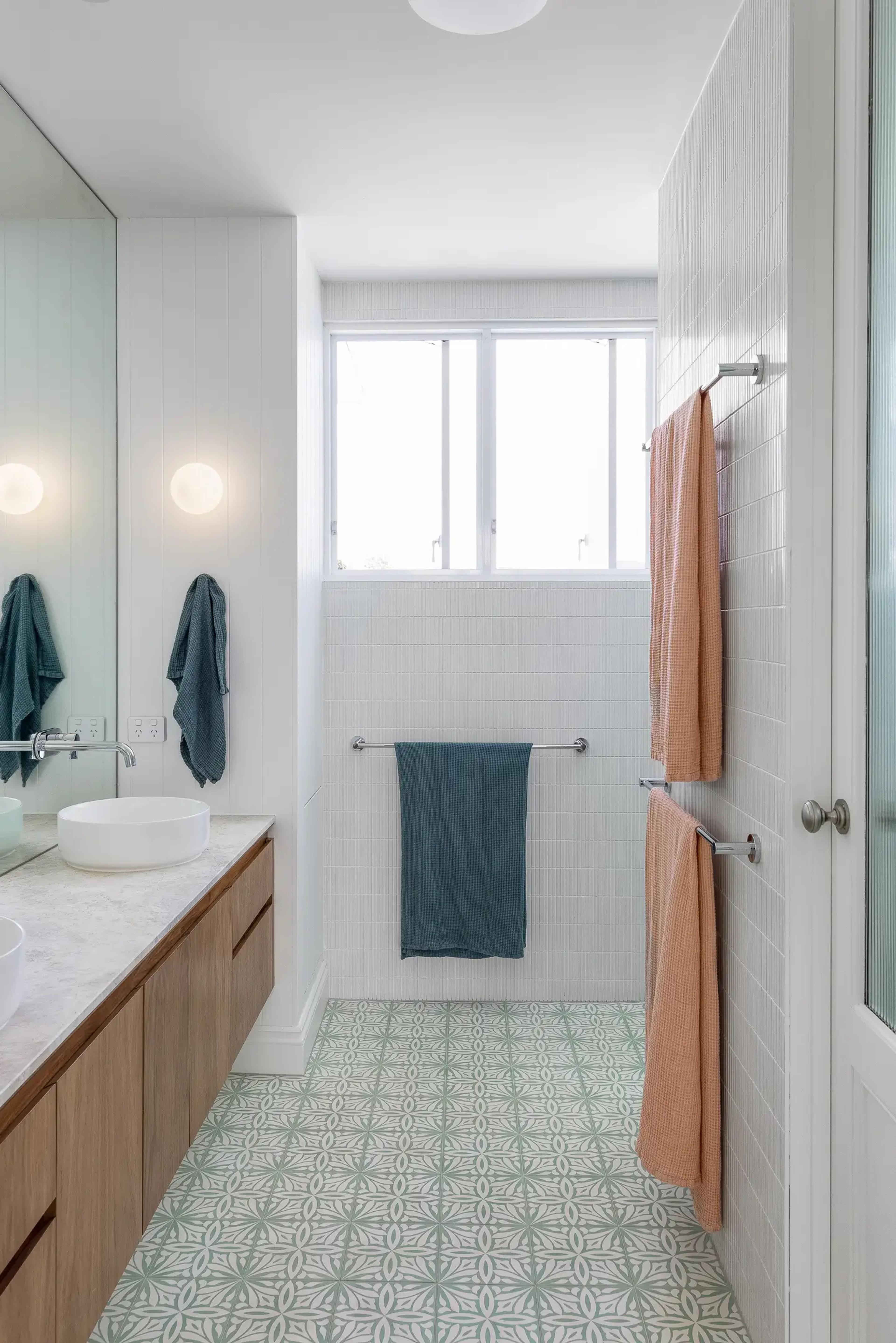 Bathroom vanity with round basin and patterned floor tiles