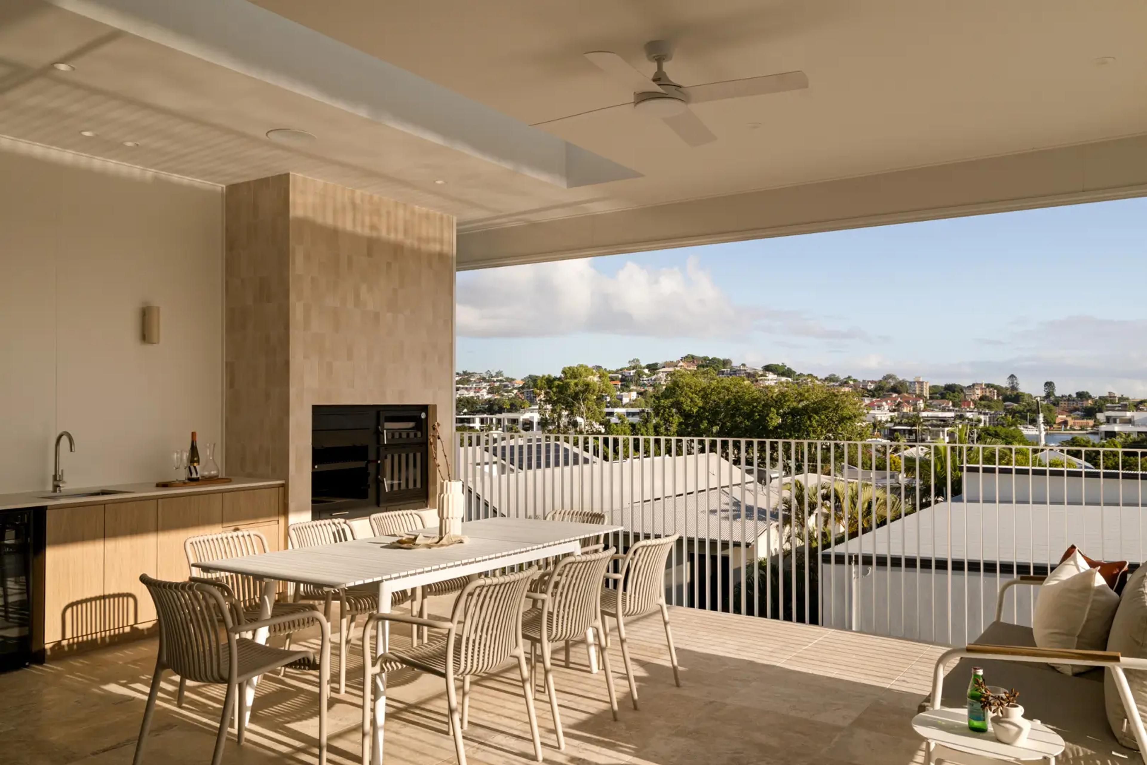 Covered terrace with dining setting and suburban view