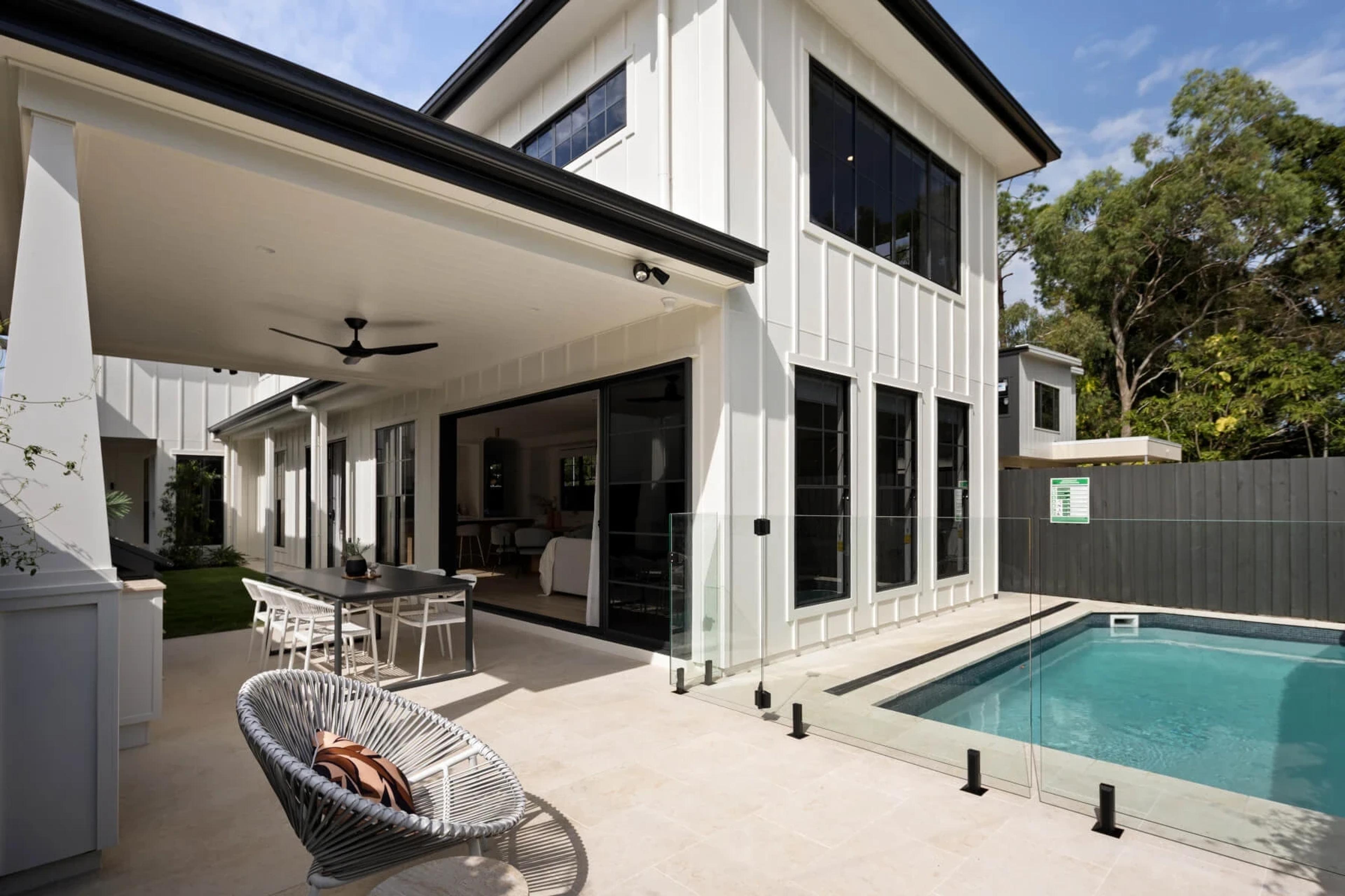 Rear alfresco terrace with dining setting and swimming pool