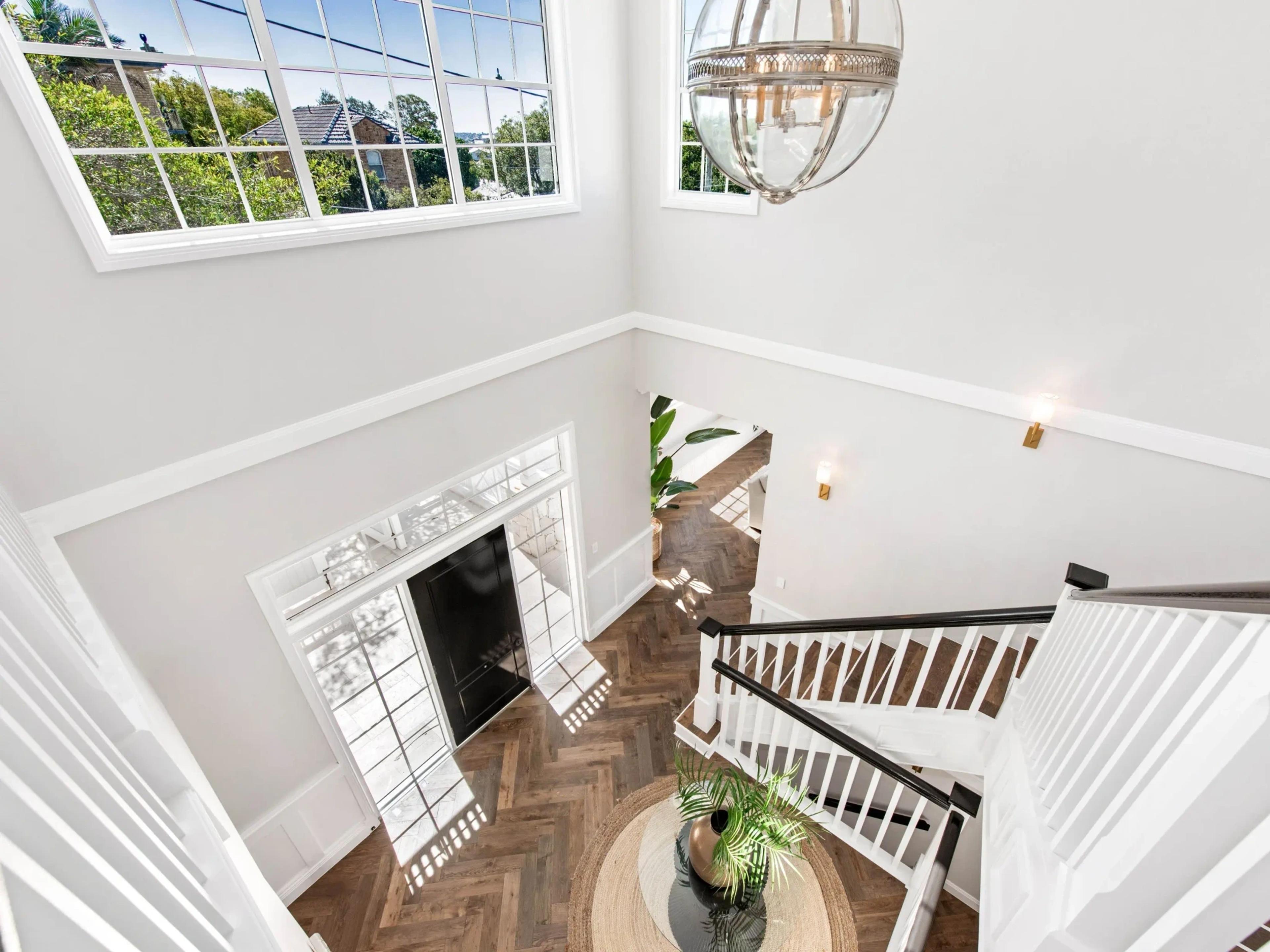 View down two storey void to herringbone floor and staircase