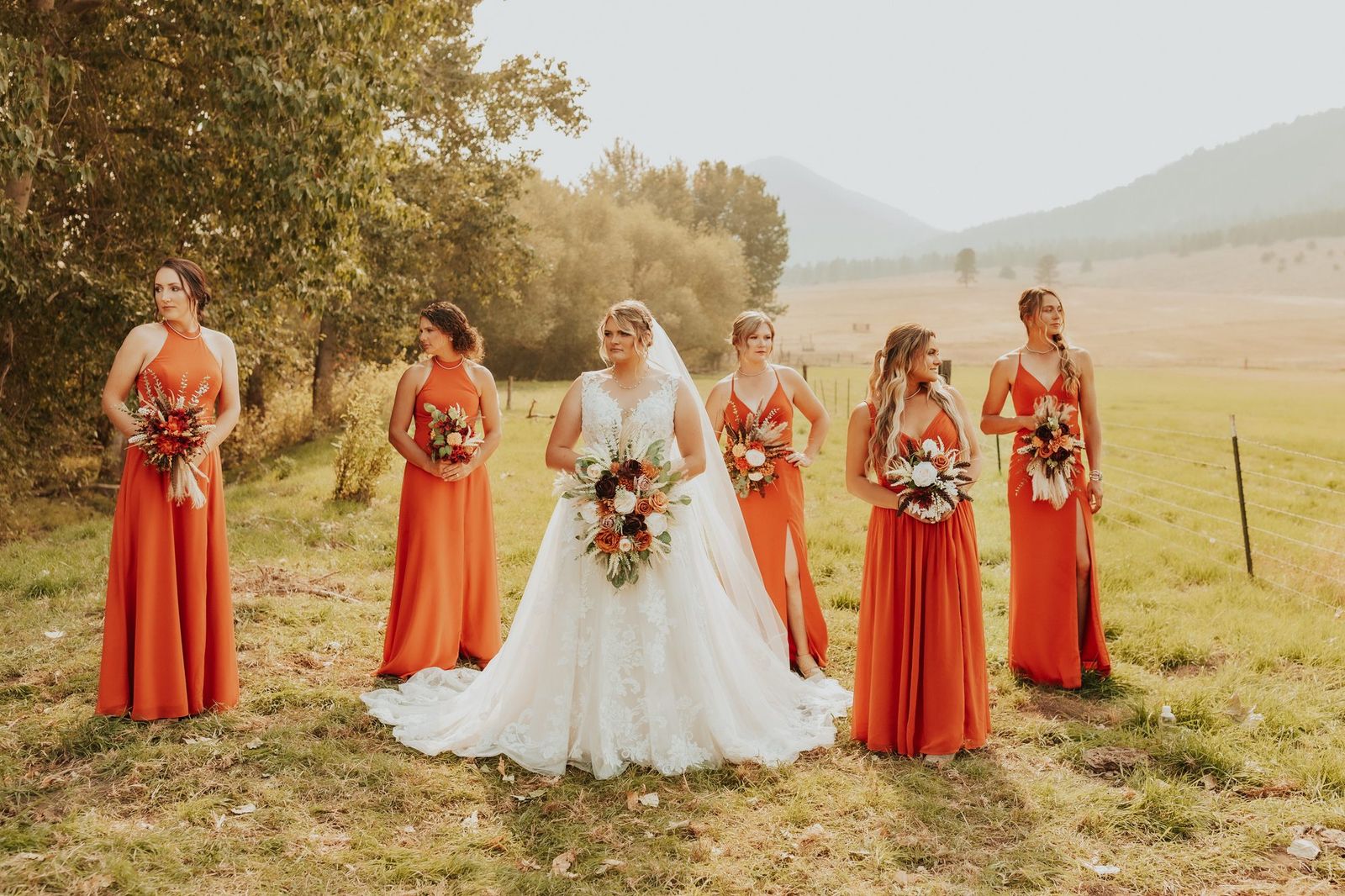 Bride with bridesmaids in orange dresses