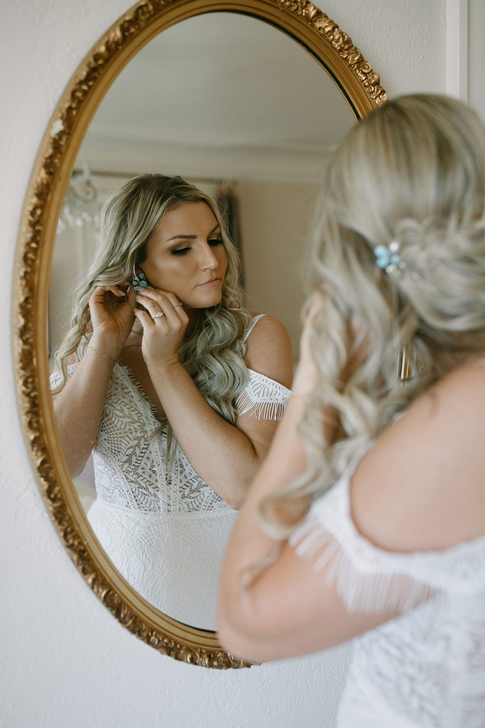 Bride getting ready in the mirror