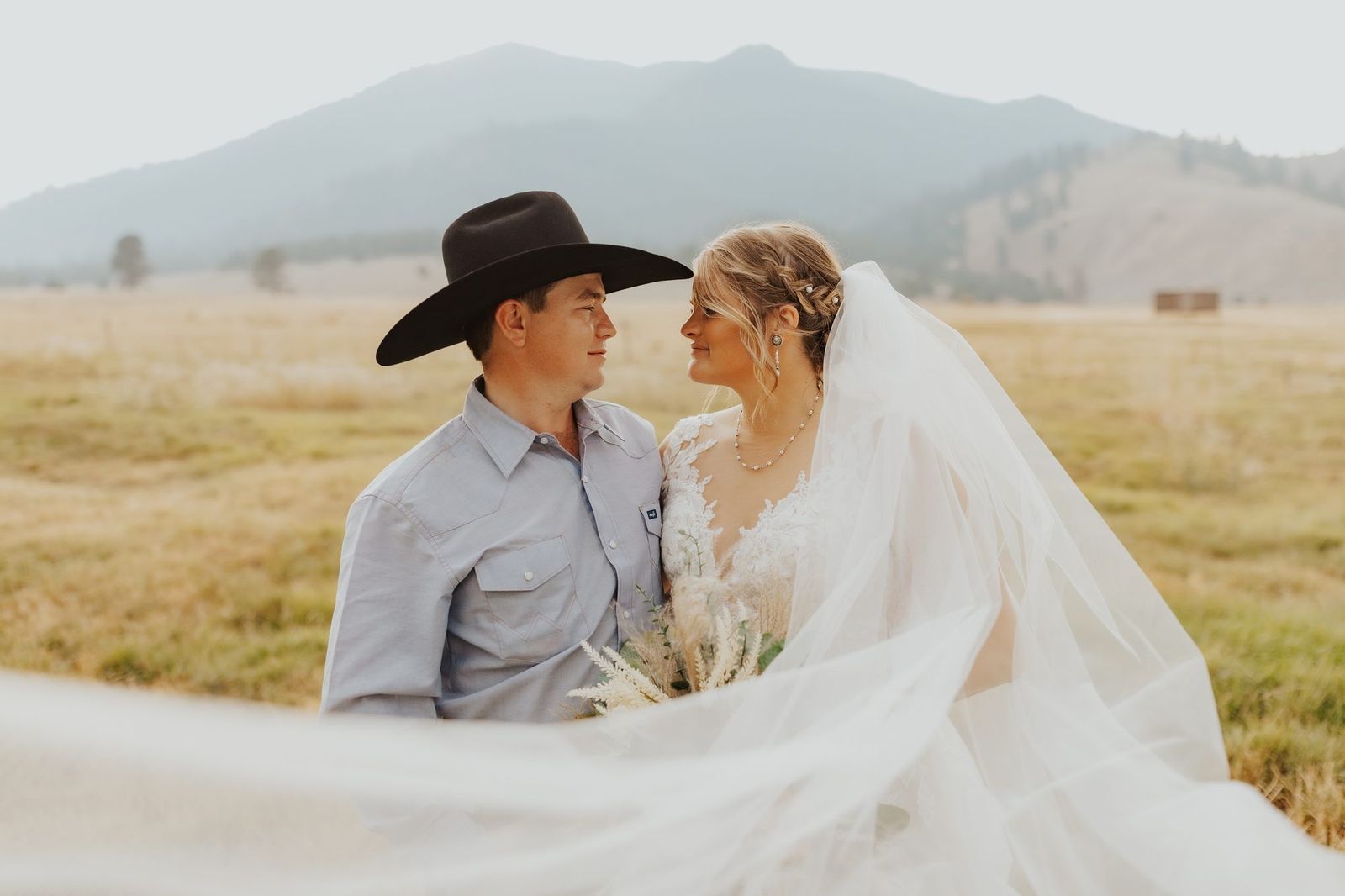 Bride's veil catching the wind with the mountains behind