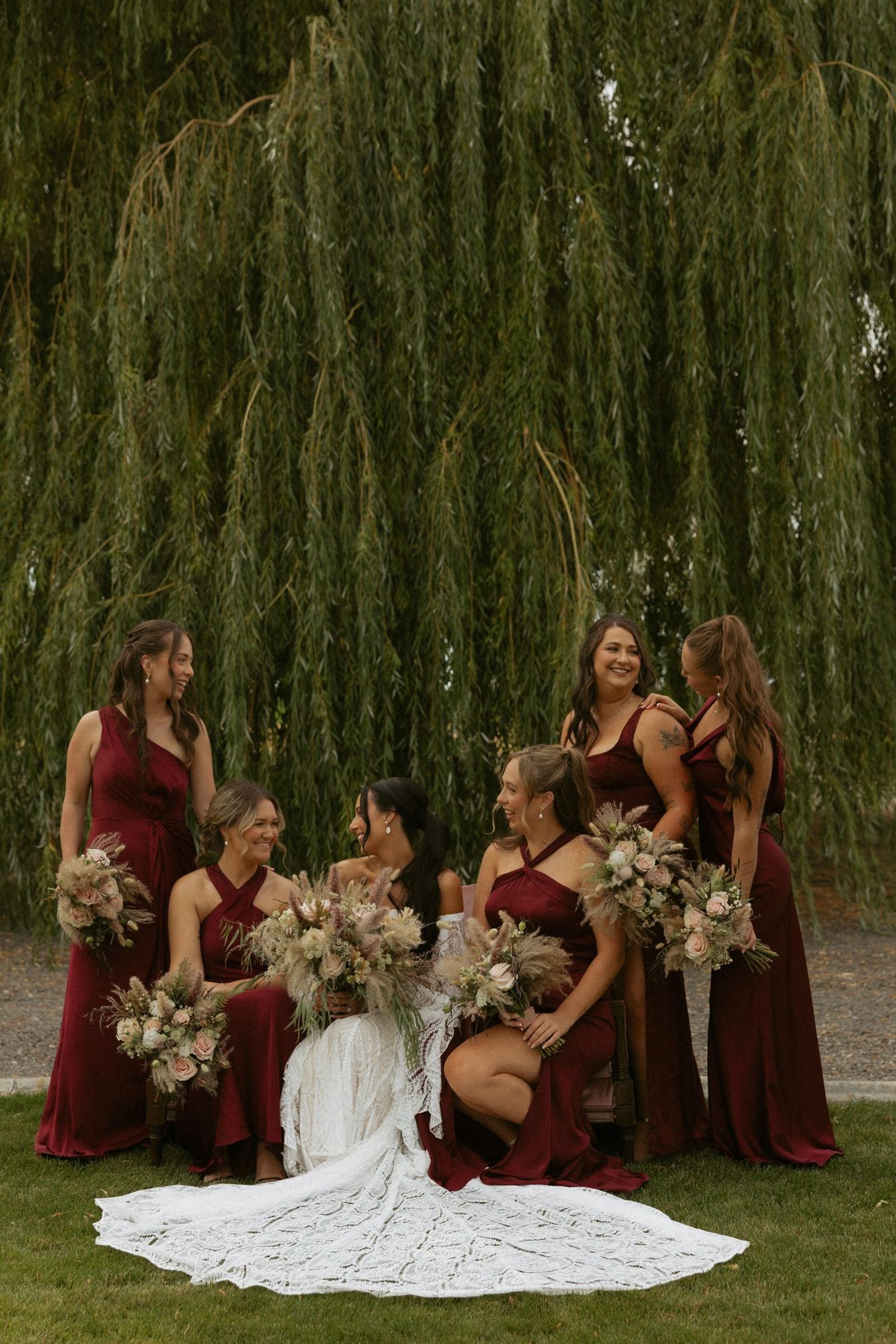Bridesmaids in burgundy beneath the willow