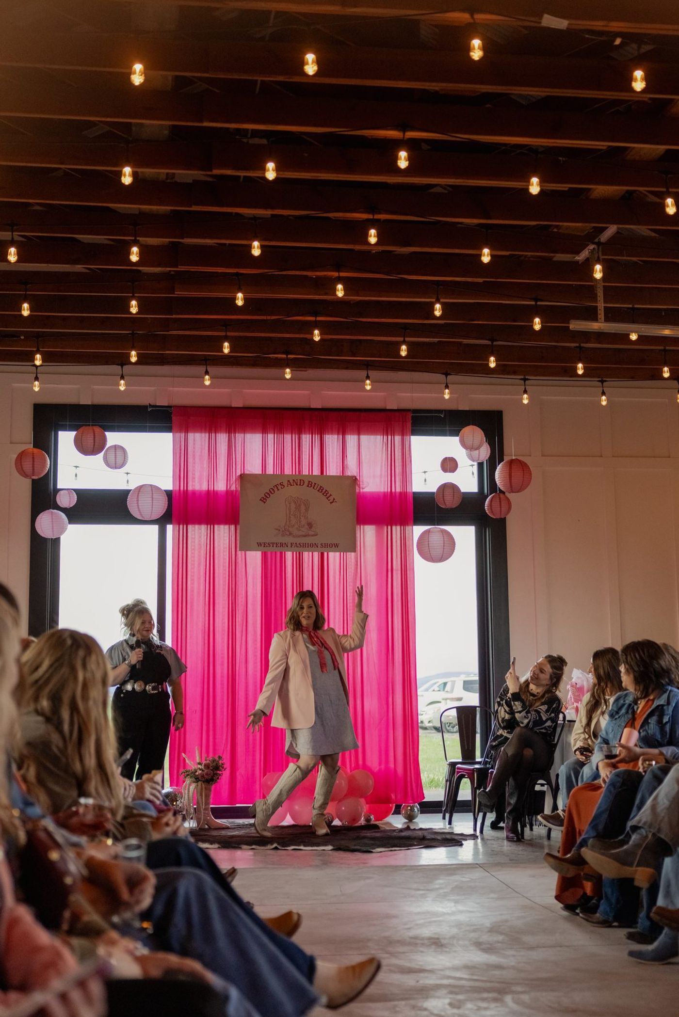 The Boots and Bubbly runway with hot pink drapes and paper lanterns