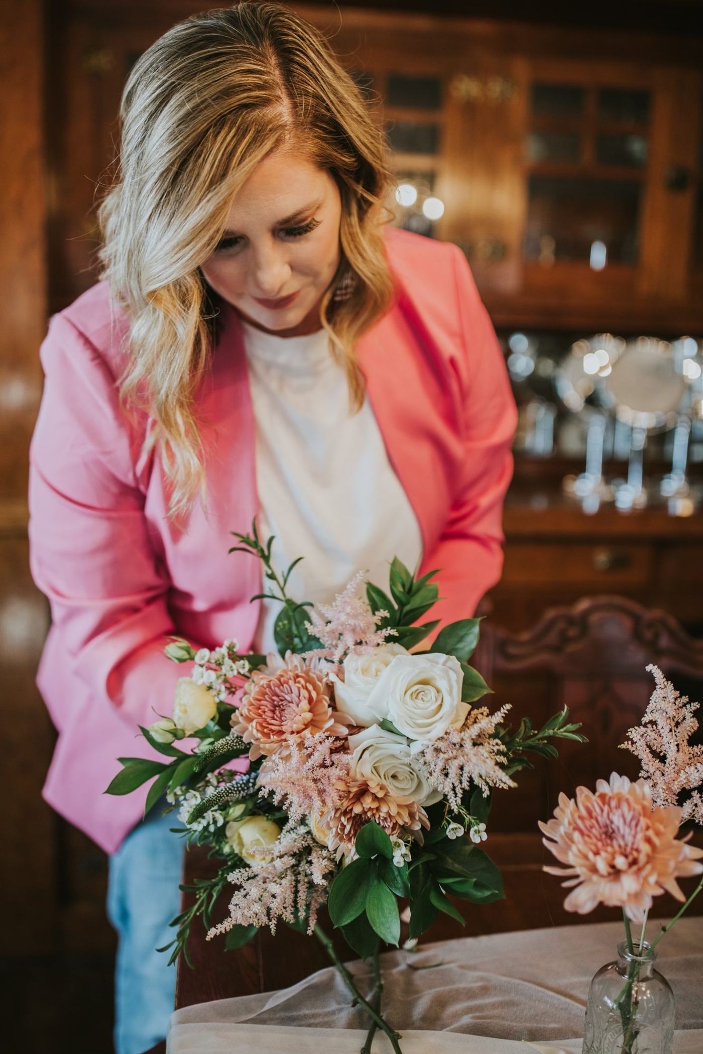 Kari holding a bouquet at a reception