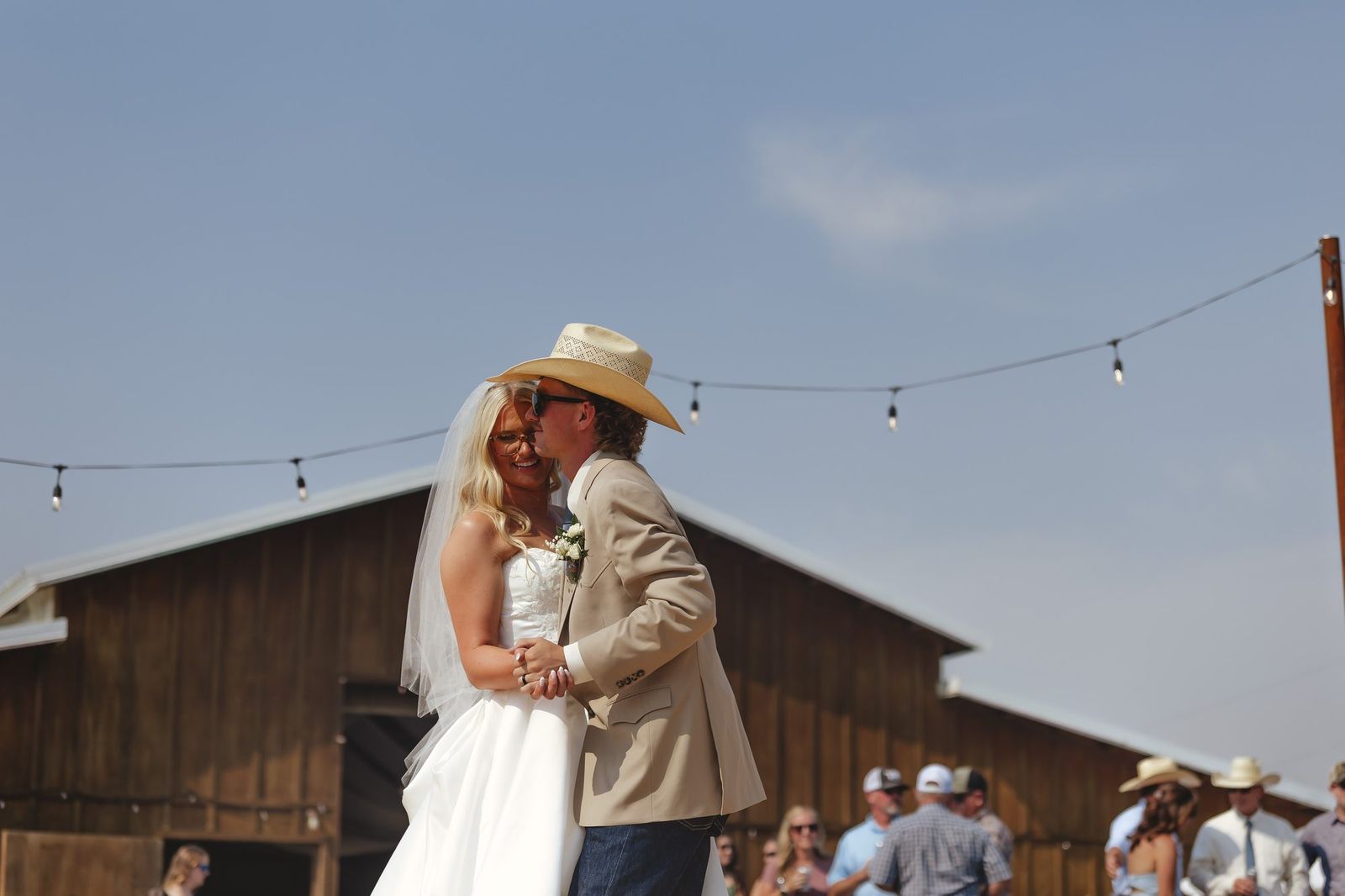 Couple under string lights at the reception