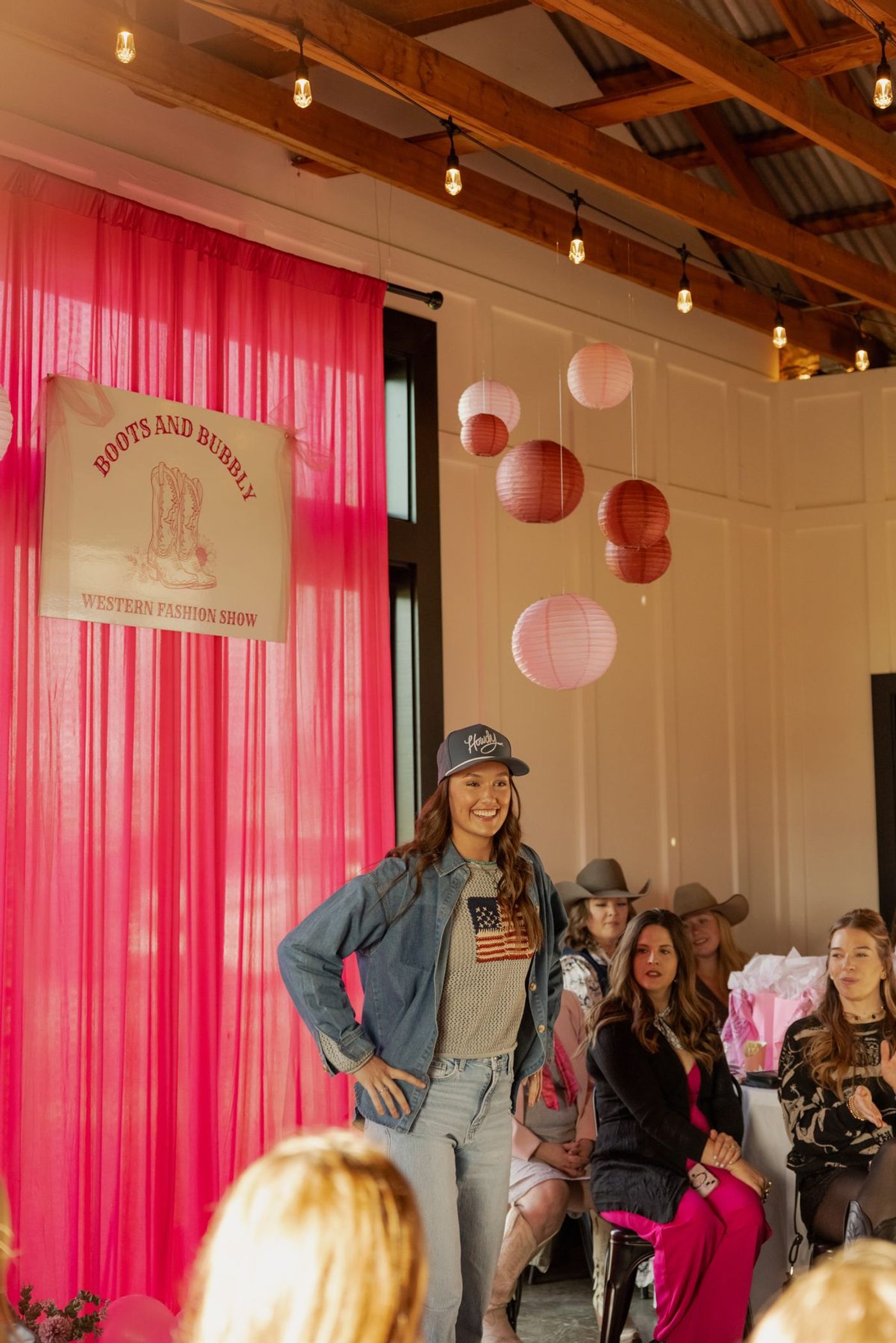 A model on the runway in denim and a ball cap