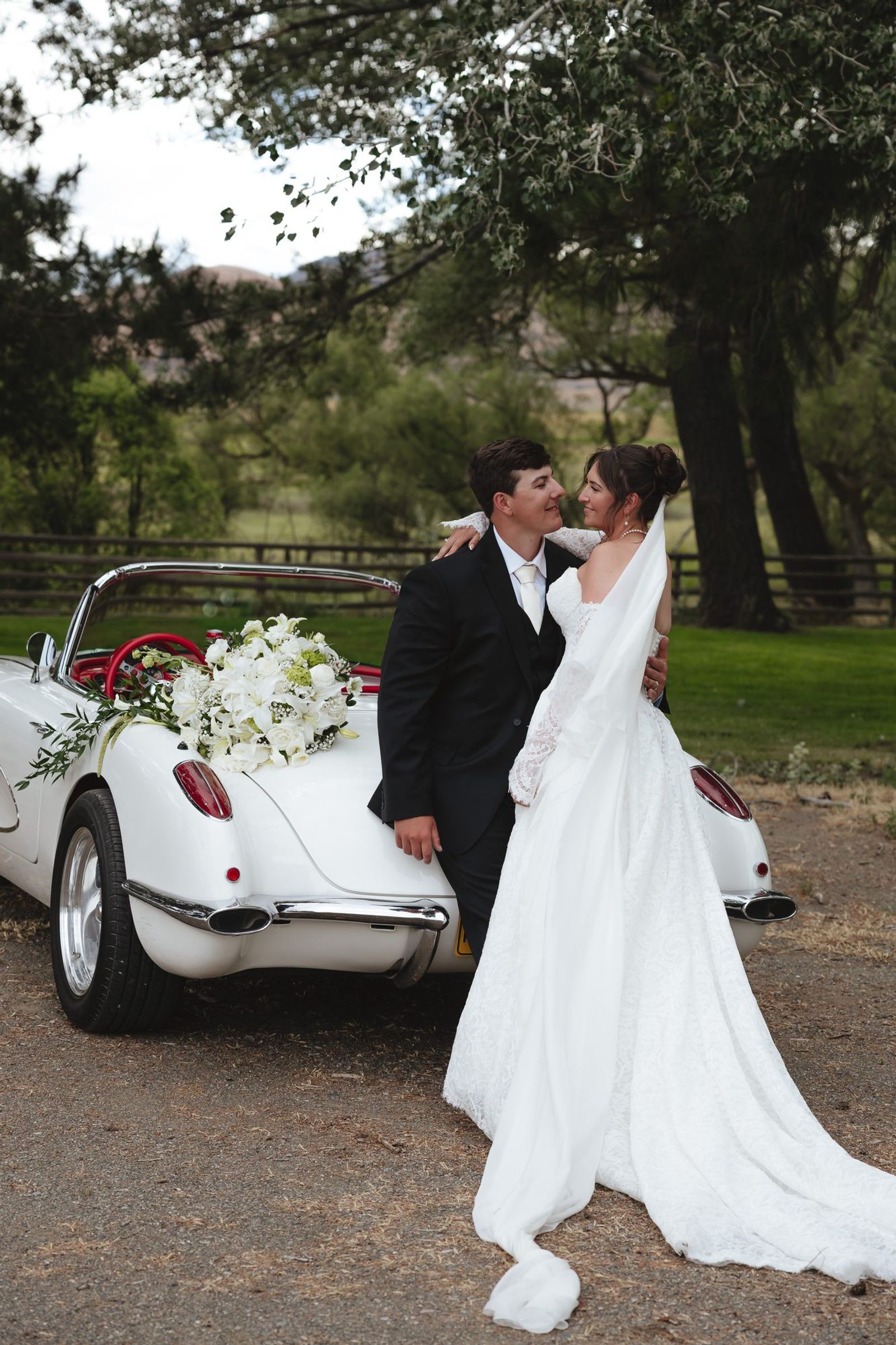 Couple beside a vintage car after the ceremony