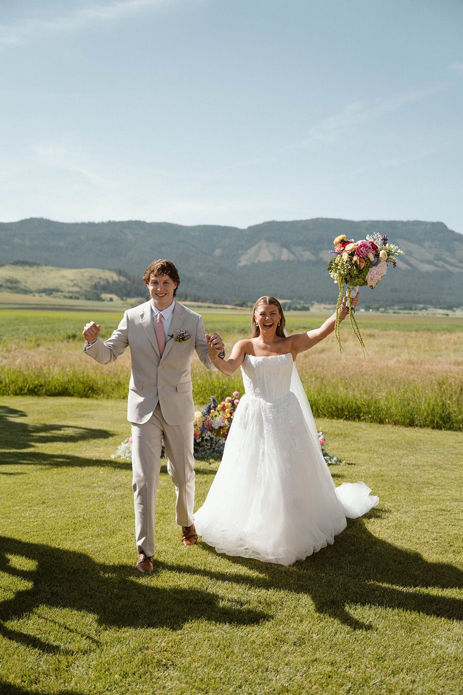 Bride and groom walking and laughing after the ceremony