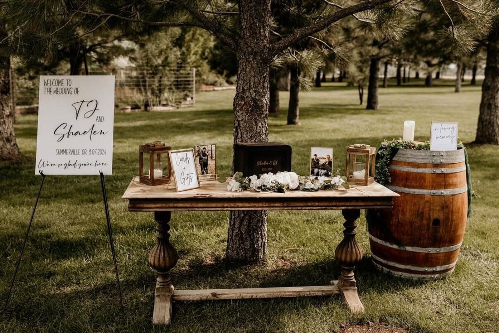 Welcome sign and gift table set under the pines