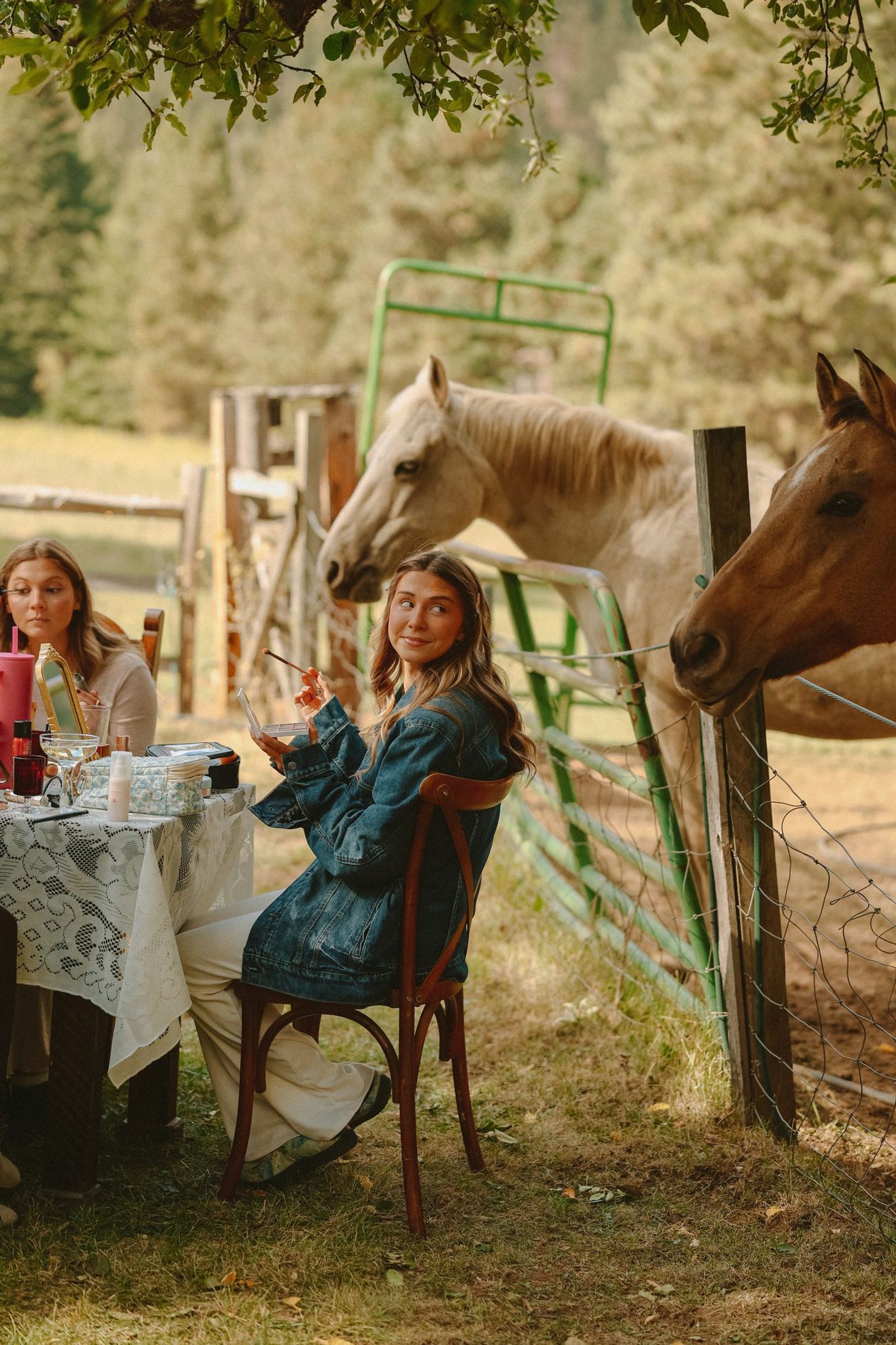 Bride at a table with horses at the fence