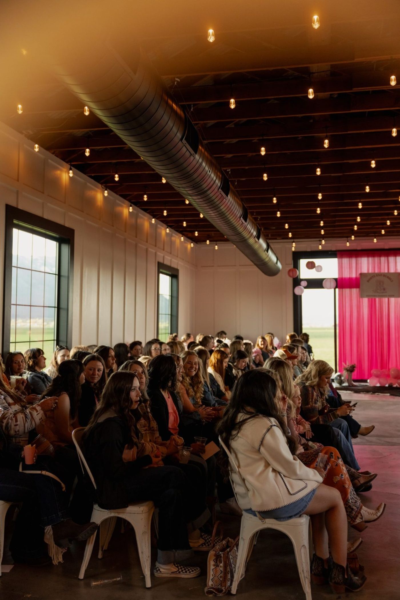 A full house seated under the string lights
