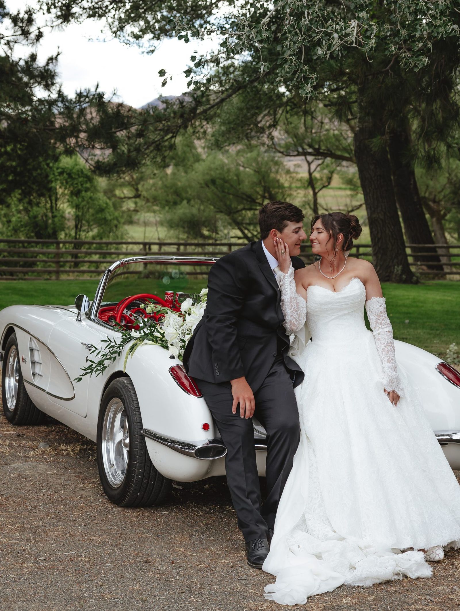 Couple beside the white vintage corvette
