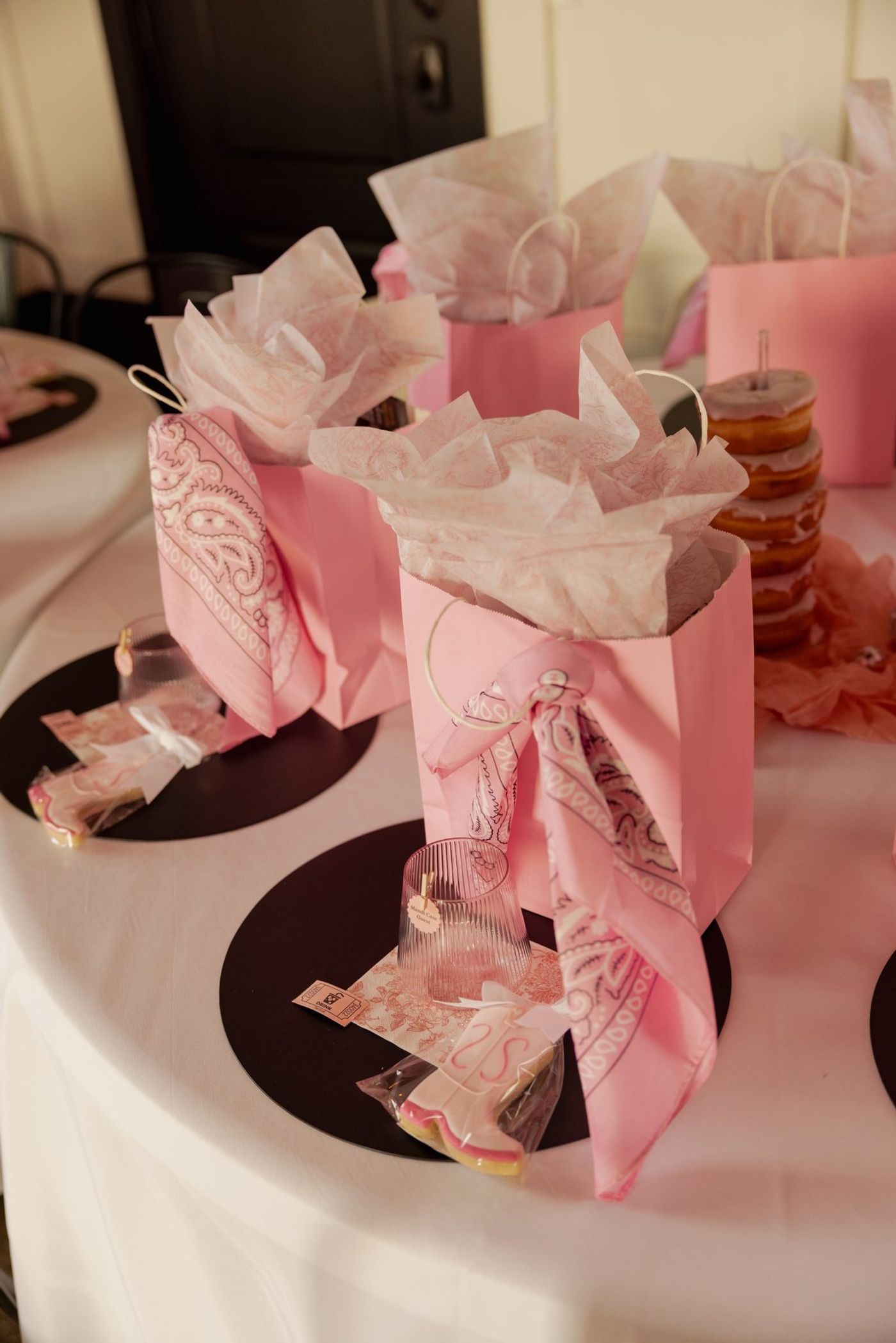 Pink bandana wrapped favor bags at each seat