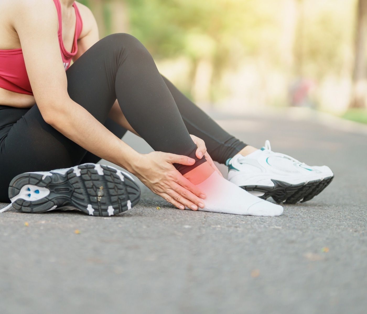 Runner holding their lower leg and ankle in pain