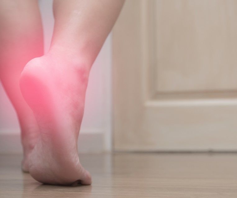 Person holding a painful heel