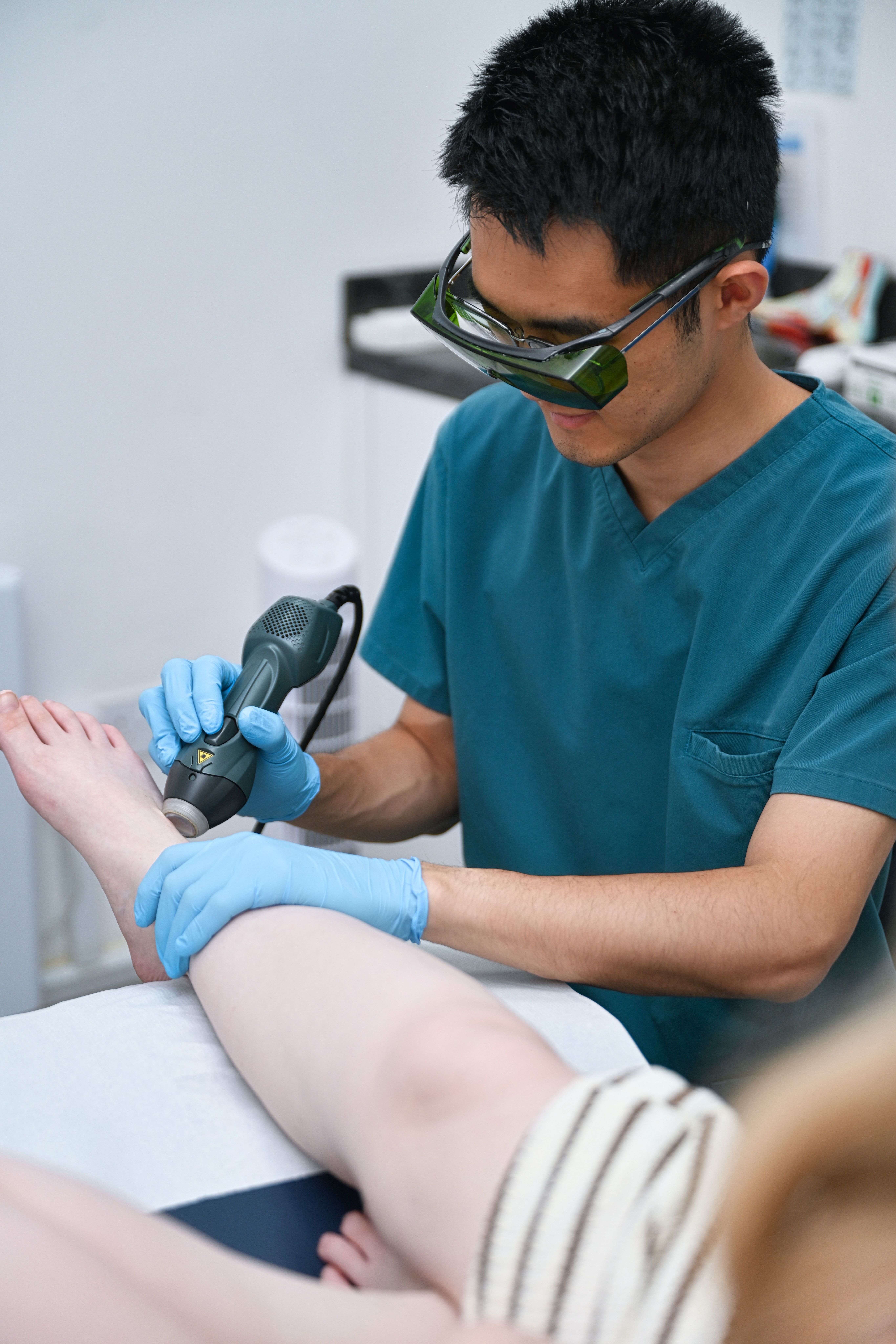 Podiatrist assessing a patient’s lower limb