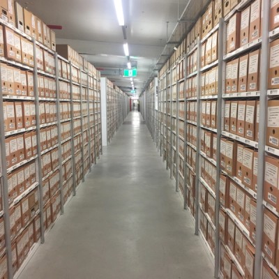 Boxes of records on storage shelving 