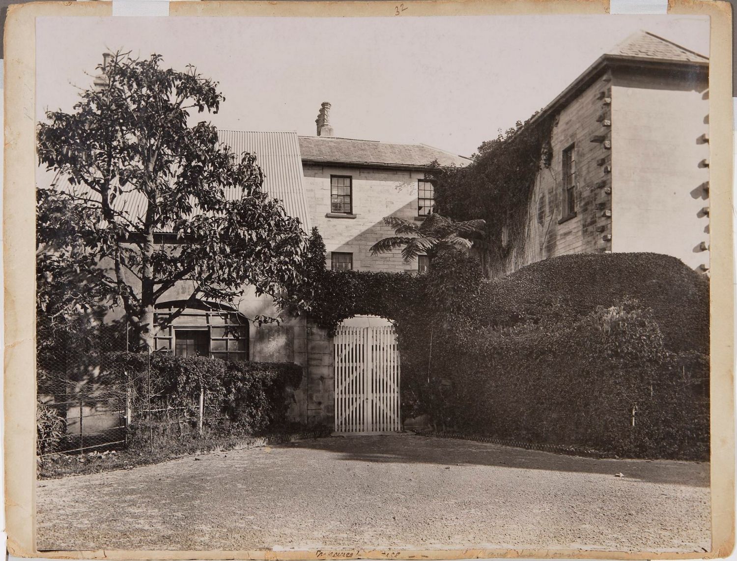Black and white photo of a large white gate and archway at the back of Vaucluse House.